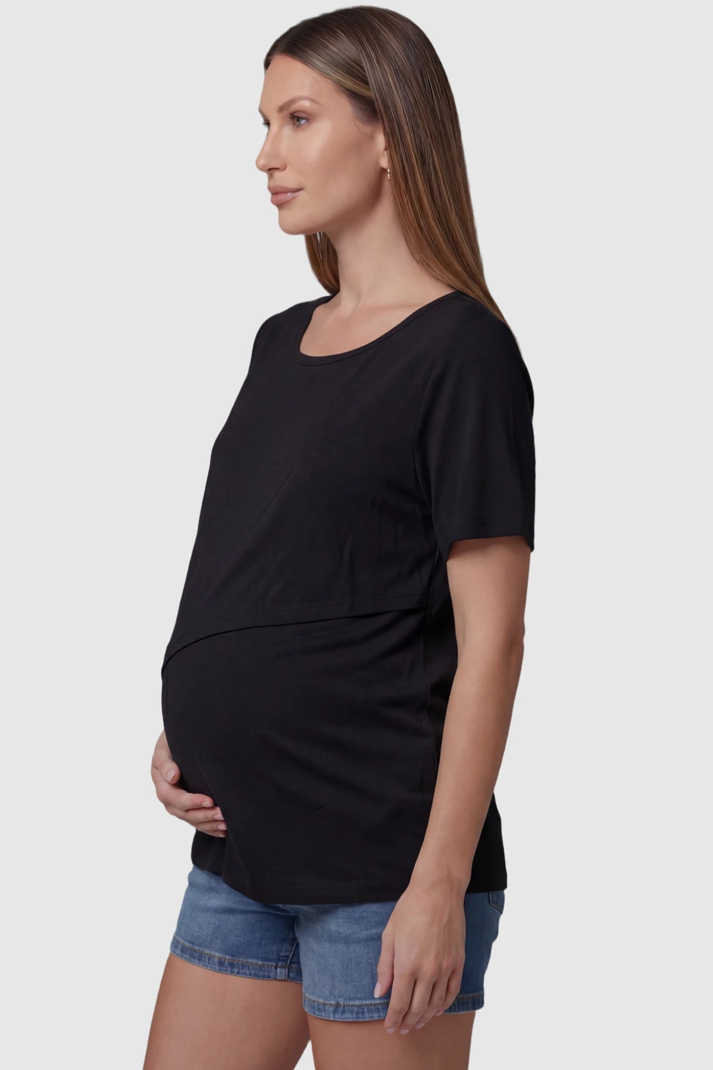 Double Layer Short Sleeve Maternity Nursing Top Double Layer Short Sleeve Maternity Nursing Top in Black featuring a discreet lift-up layer on a pregnant model side view.