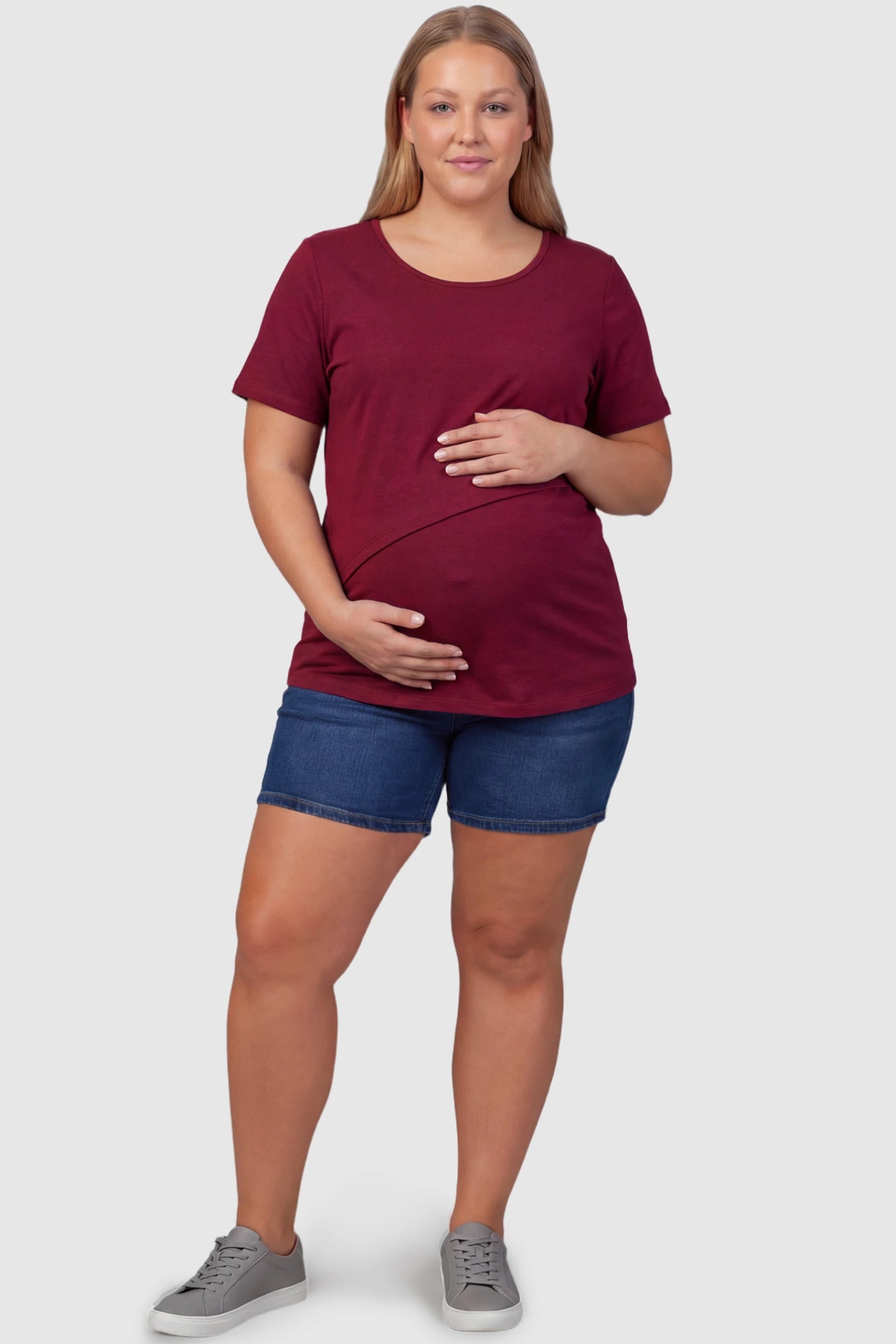 Double Layer Short Sleeve Maternity Nursing Top Double Layer Short Sleeve Maternity Nursing Top in Wine Red featuring a discreet lift-up layer on a plus size pregnant model front view.