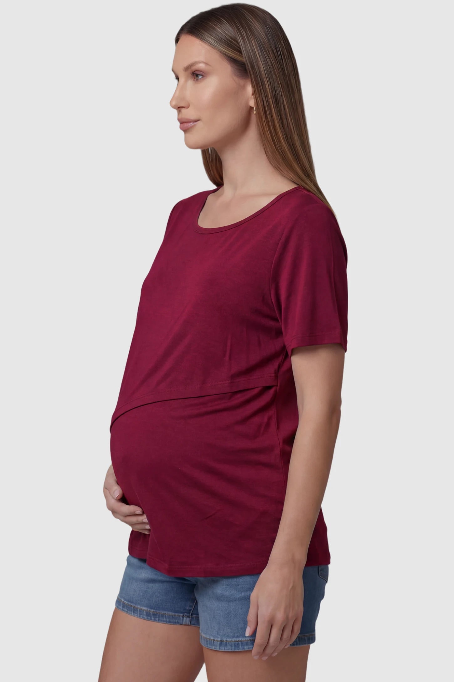 Double Layer Short Sleeve Maternity Nursing Top Double Layer Short Sleeve Maternity Nursing Top in Wine Red featuring a discreet lift-up layer on a pregnant model side view.