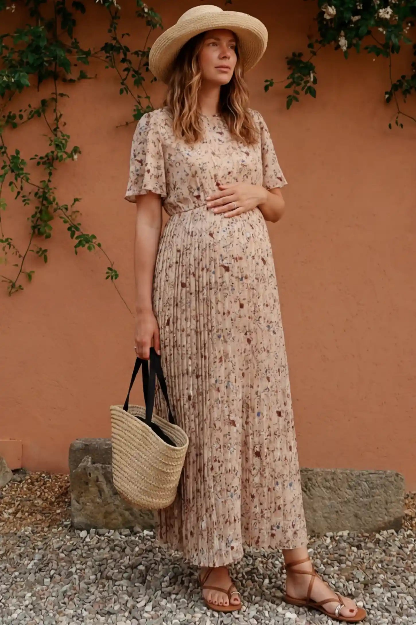 Floral Print Round Neck Pleated Maternity Midi Dress Floral Print Round Neck Pleated Maternity Midi Dress in Beige Floral Print featuring a pleated A-line skirt on a pregnant woman in outdoor setting , front view.