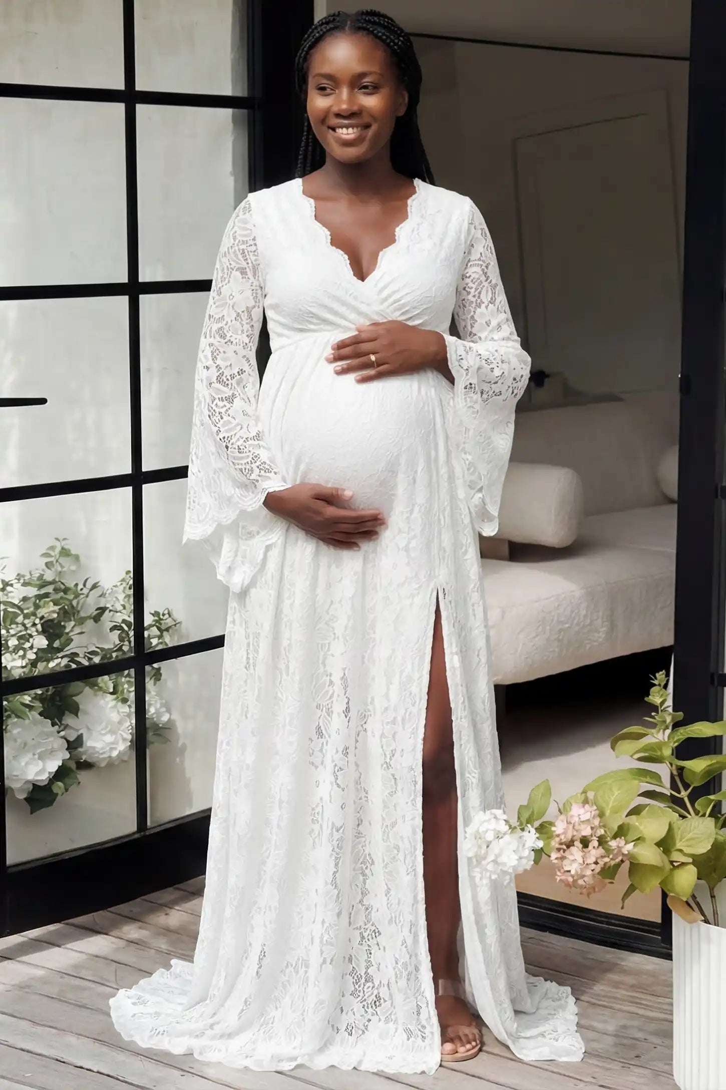 Lace Flare Long Sleeve Maternity Photoshoot Gown in White featuring floor-length flared sleeves on a pregnant model.