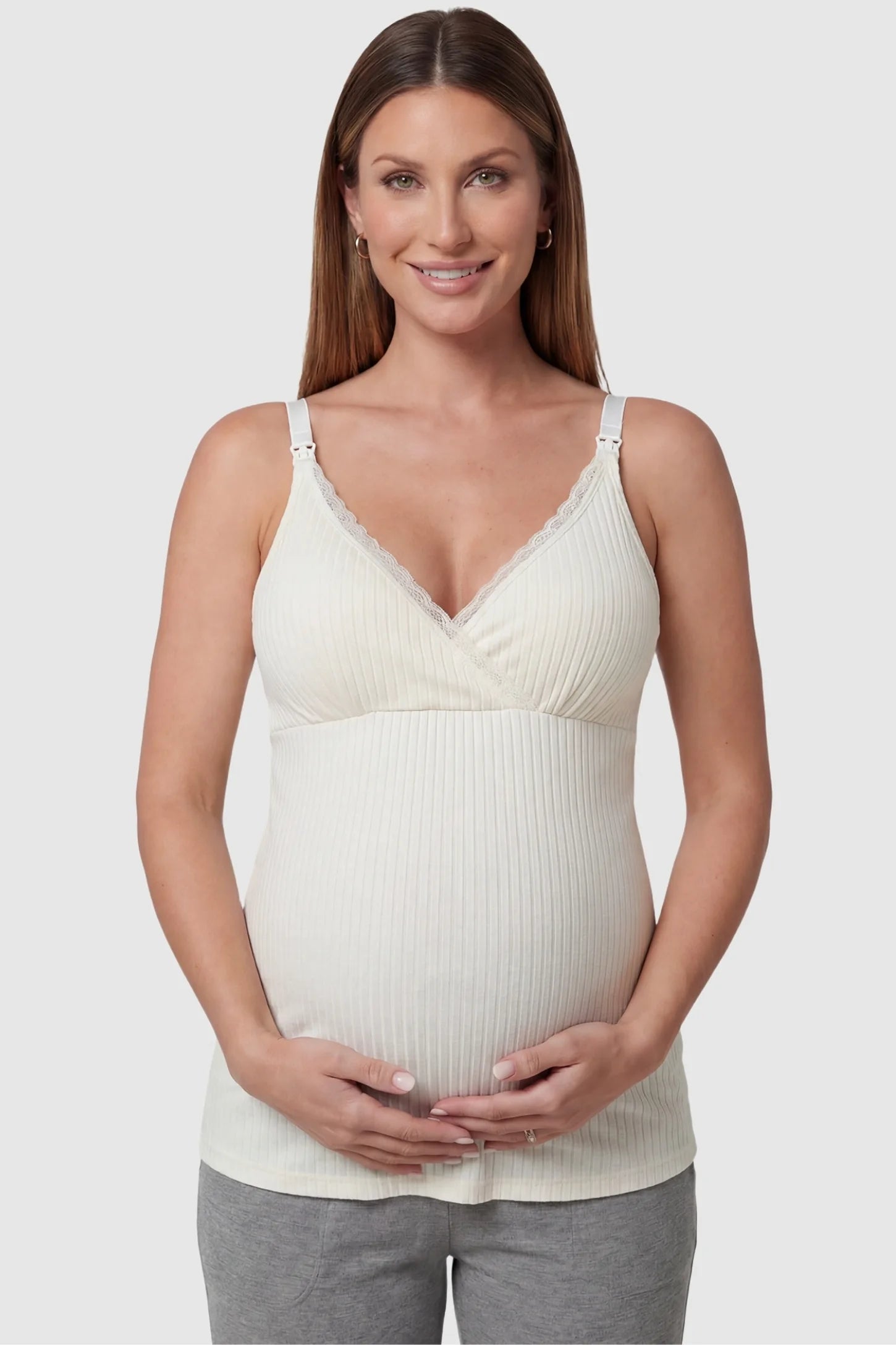 Padded Ribbed Maternity & Nursing Camisole Cream White Padded Ribbed Maternity Camisole with lace-trim V-neckline on a pregnant model in a front view.