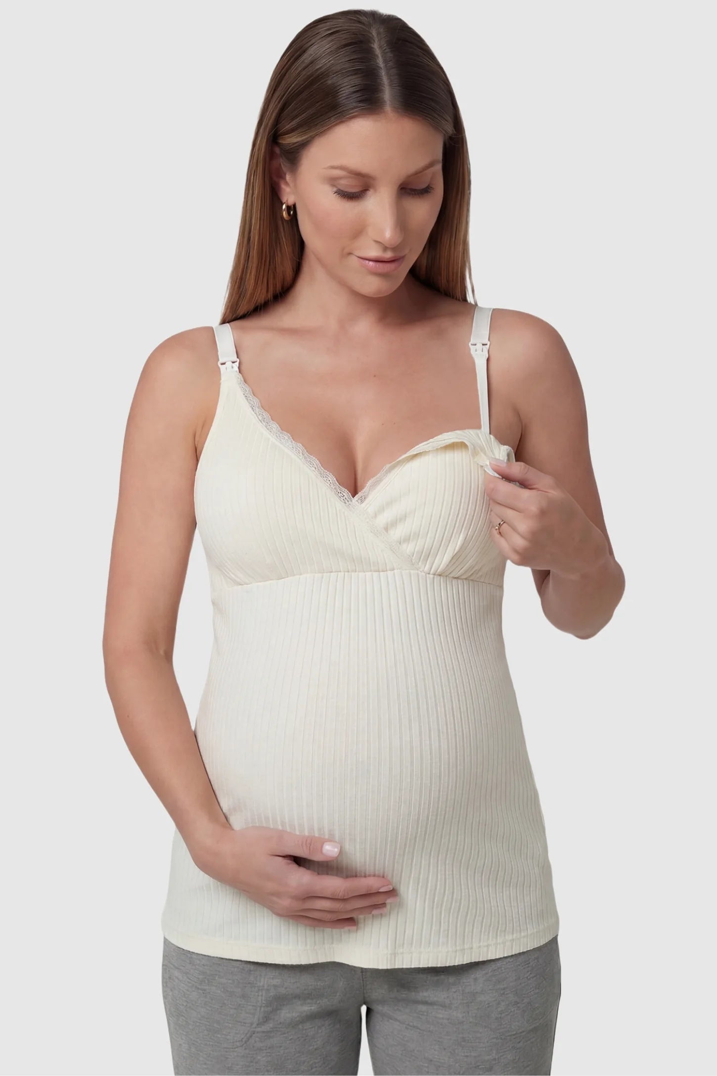 Padded Ribbed Maternity & Nursing Camisole Cream White Padded Ribbed Maternity Camisole with easy nursing access on a pregnant model in a front view.
