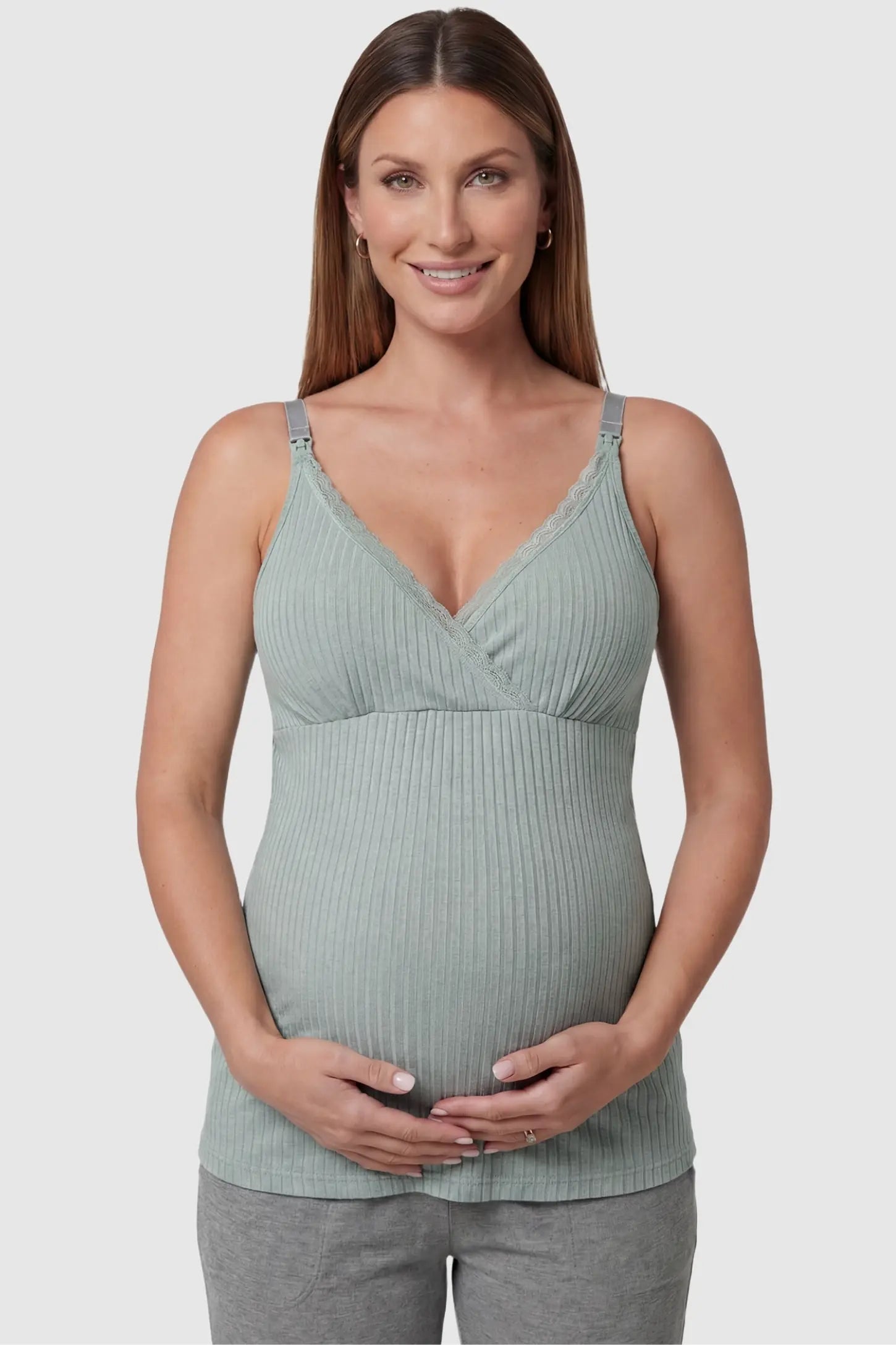 Padded Ribbed Maternity & Nursing Camisole Pea Green Padded Ribbed Maternity Camisole with lace-trim V-neckline on a pregnant model in a front view.