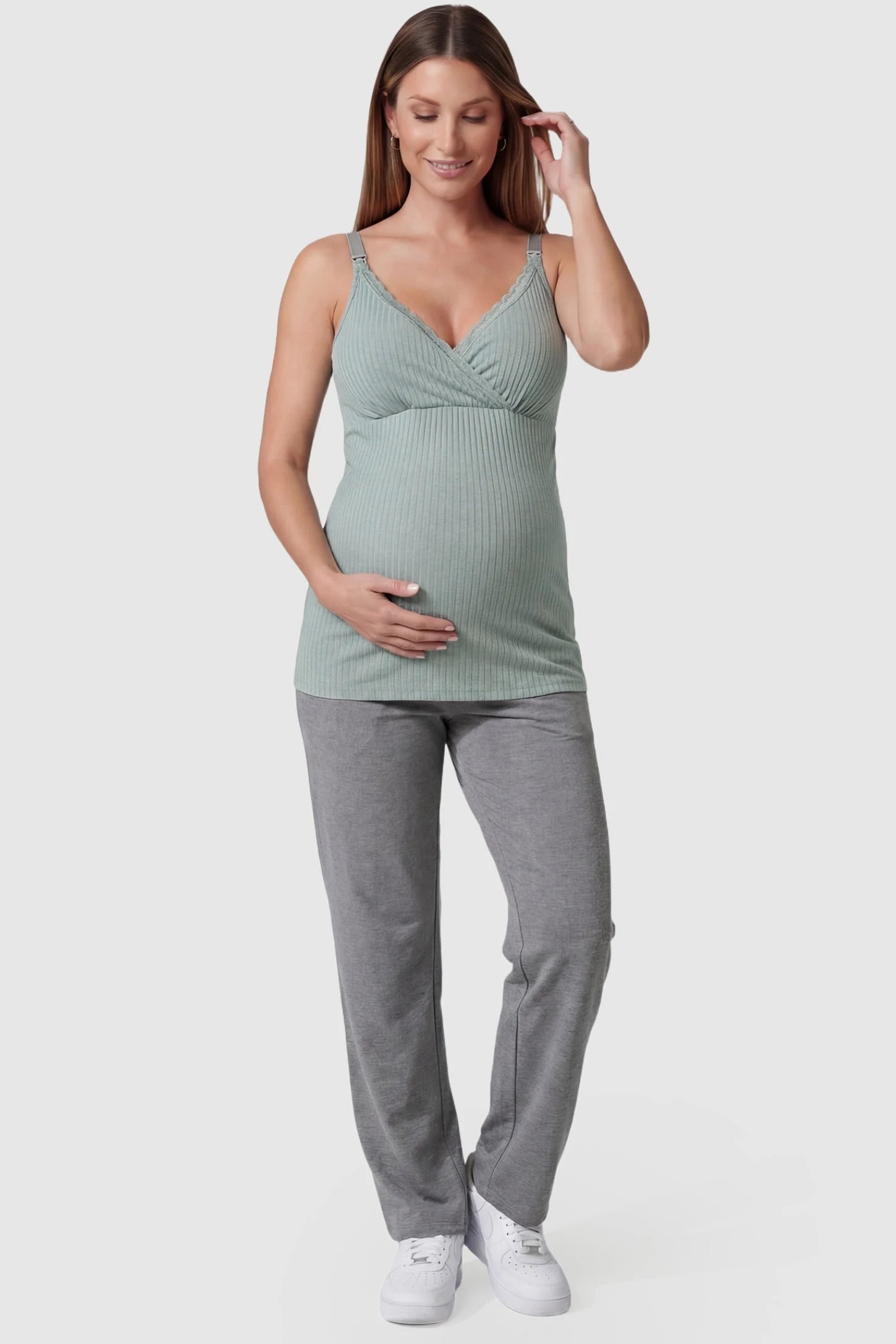 Padded Ribbed Maternity & Nursing Camisole Pea Green Padded Ribbed Maternity Camisole with lace-trim V-neckline on a pregnant model in a front view.