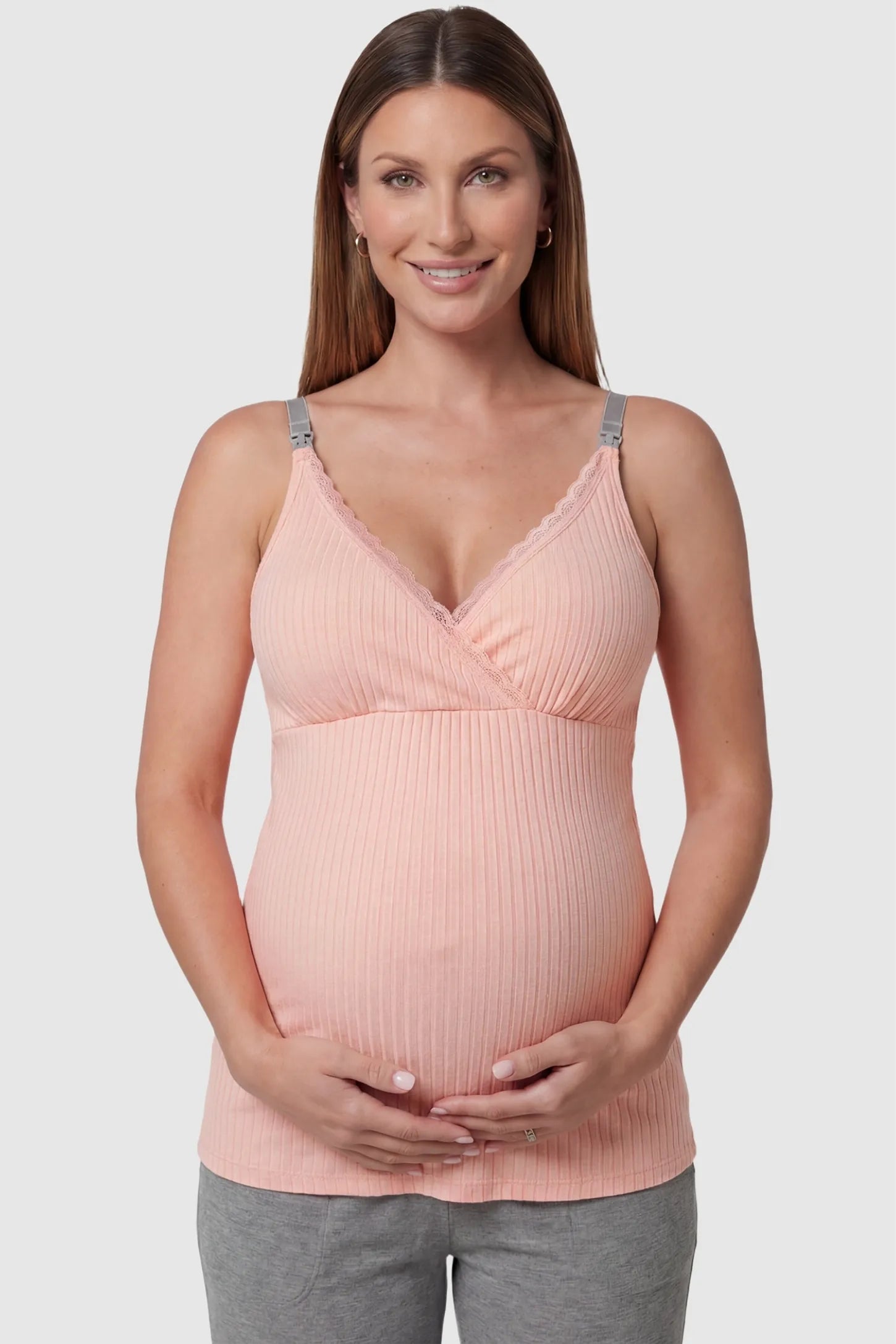 Padded Ribbed Maternity & Nursing Camisole Pink Padded Ribbed Maternity Camisole with lace-trim V-neckline on a pregnant model in a front view.