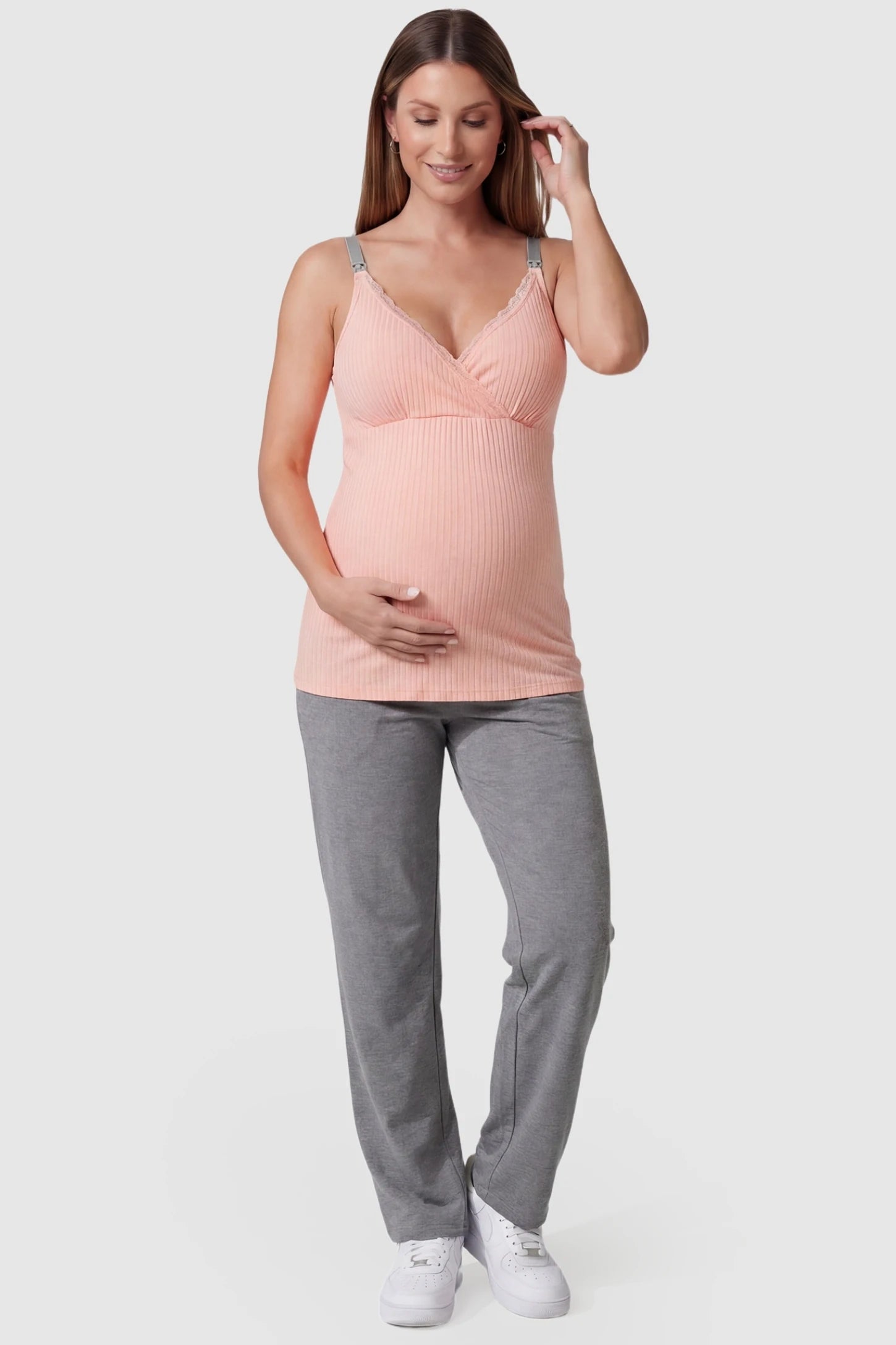 Padded Ribbed Maternity & Nursing Camisole Pink Padded Ribbed Maternity Camisole with lace-trim V-neckline on a pregnant model in a front view.