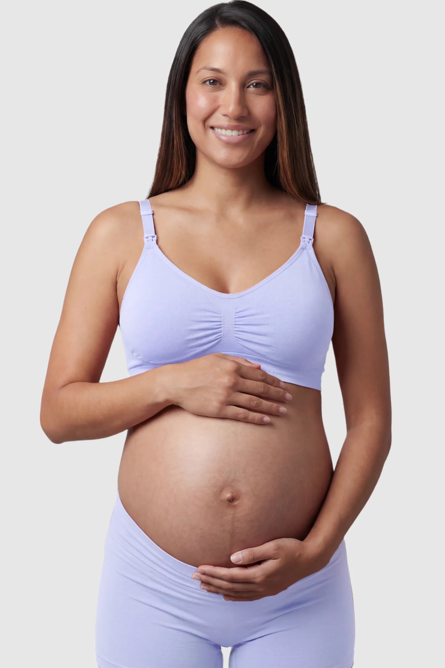 Seamless Ruched Front Maternity Nursing Bra Seamless Ruched Front Maternity Nursing Bra in blue featuring ribbed fabric and drop-down clips on a pregnant model showing front.