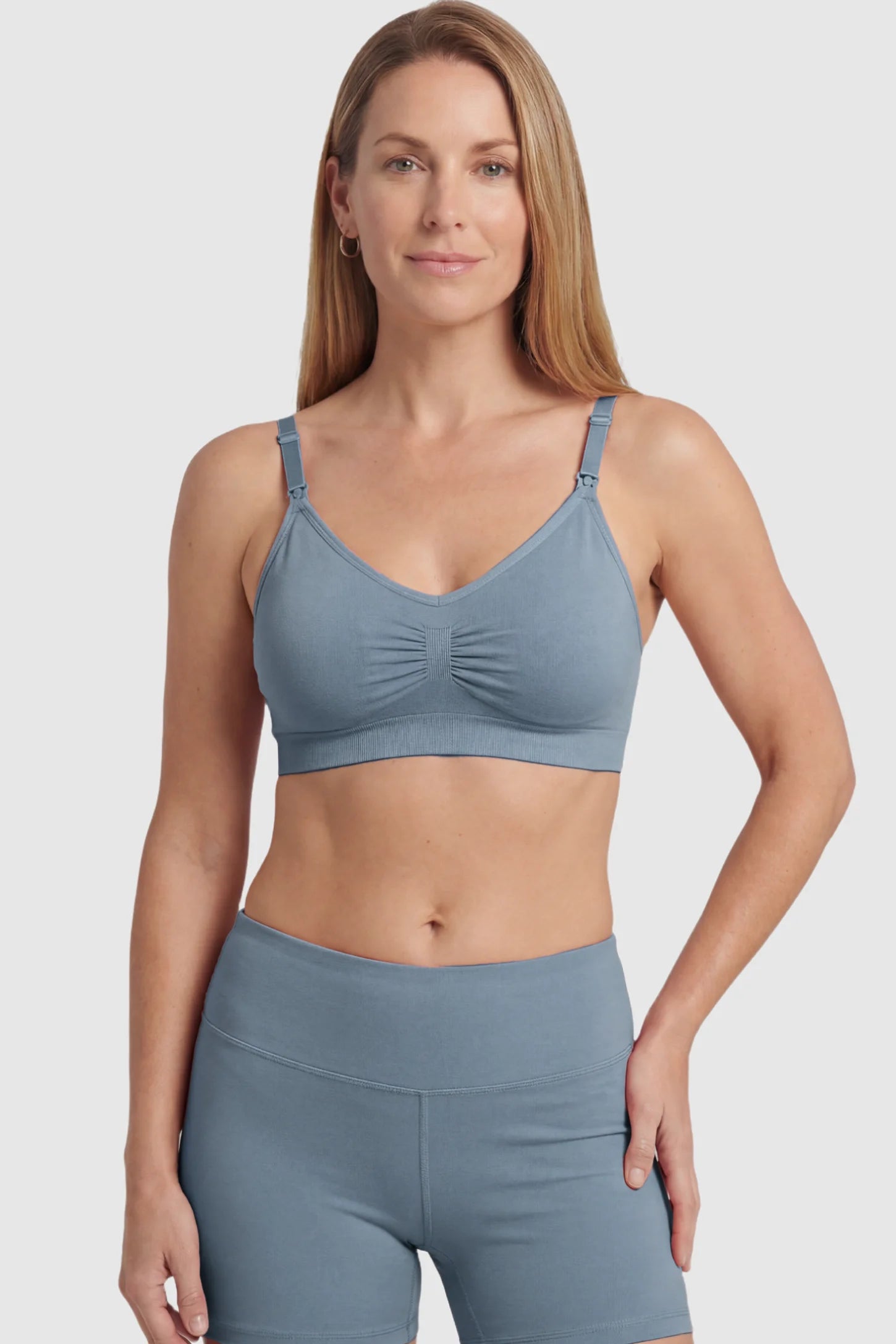 Seamless Ruched Front Maternity Nursing Bra Seamless Ruched Front Maternity Nursing Bra in gray featuring ribbed fabric and drop-down clips on a postpartum model showing front.