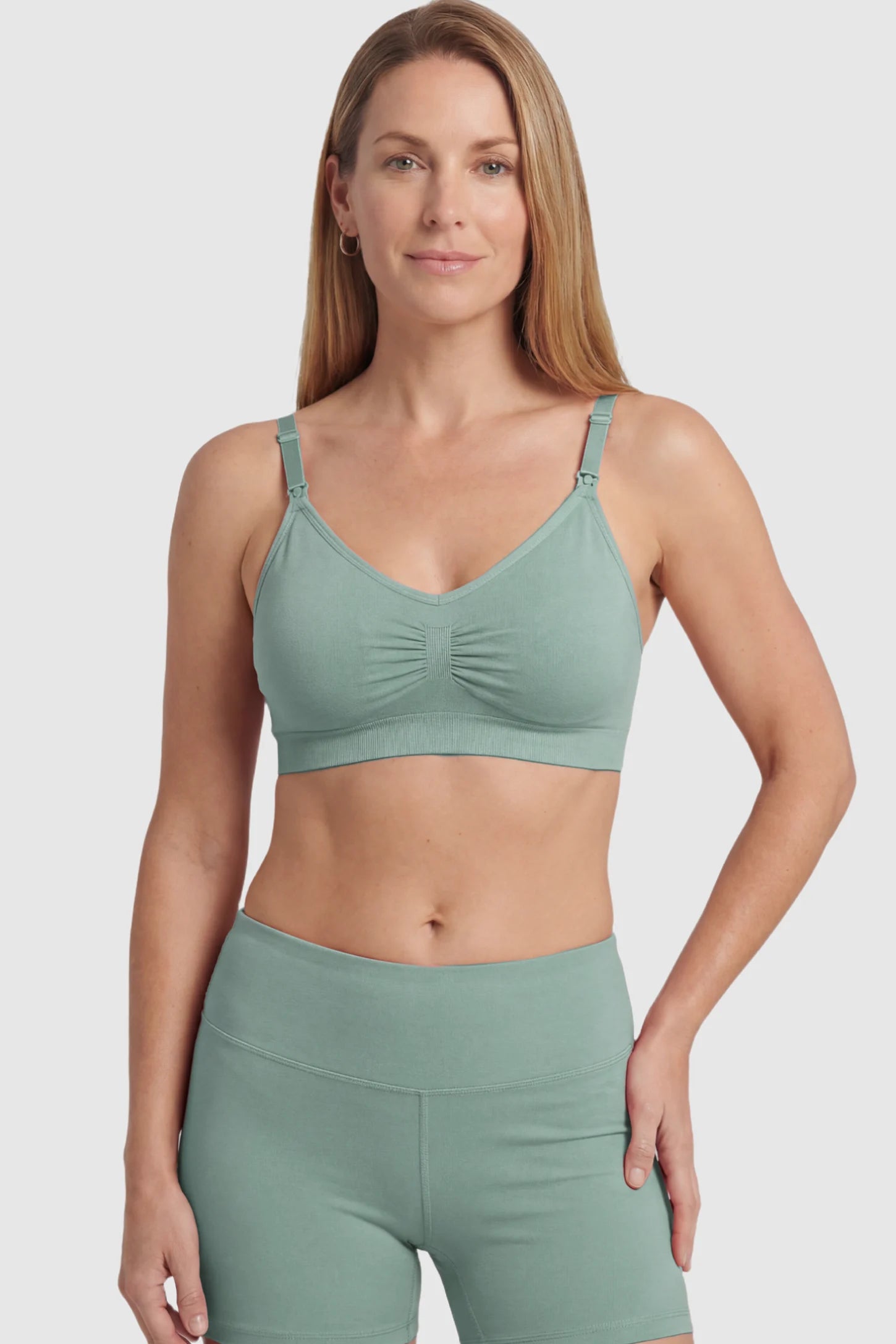 Seamless Ruched Front Maternity Nursing Bra Seamless Ruched Front Maternity Nursing Bra in green featuring ribbed fabric and drop-down clips on a postpartum model showing front.