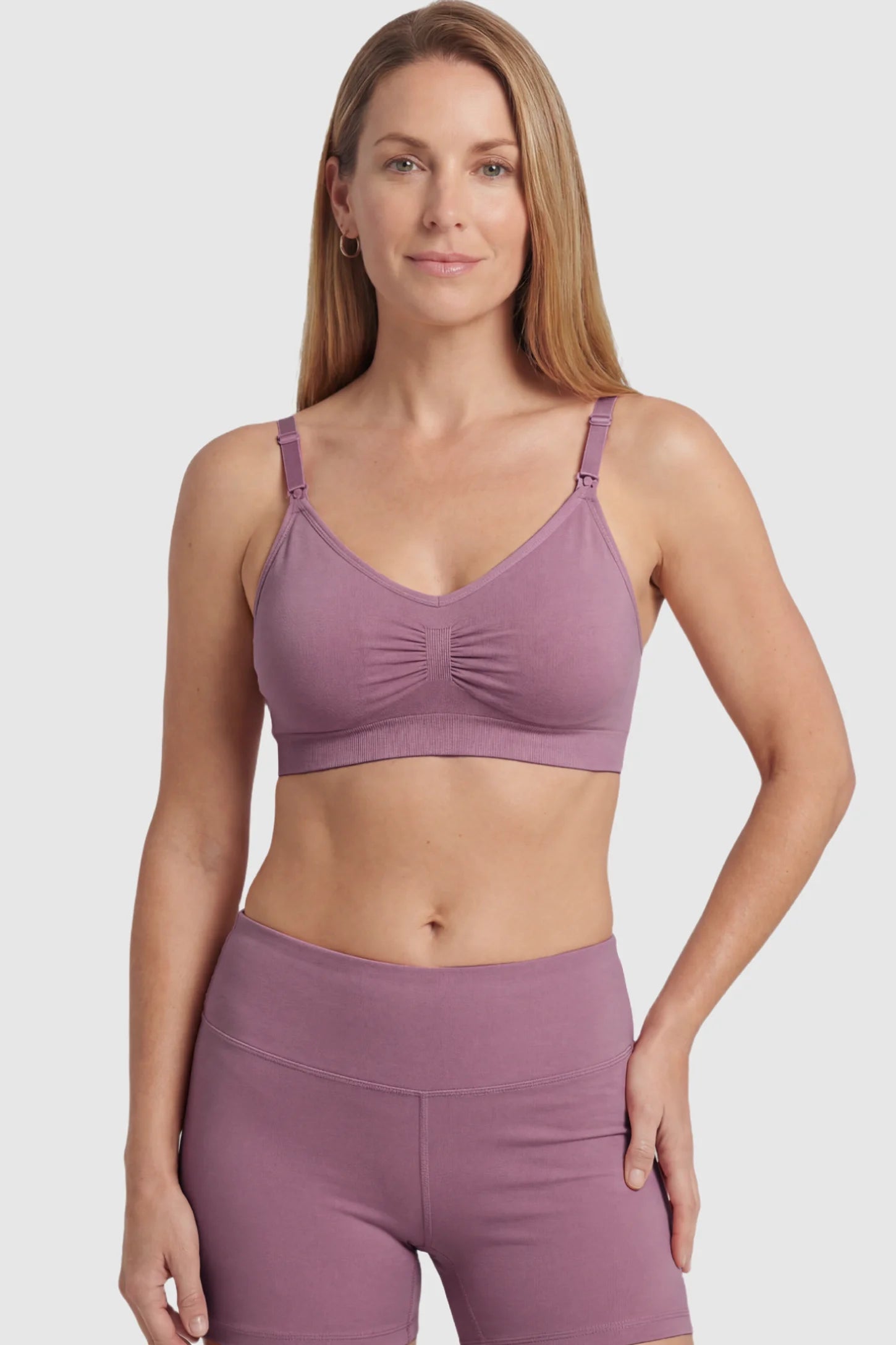 Seamless Ruched Front Maternity Nursing Bra Seamless Ruched Front Maternity Nursing Bra in purple featuring ribbed fabric and drop-down clips on a postpartum model showing front.