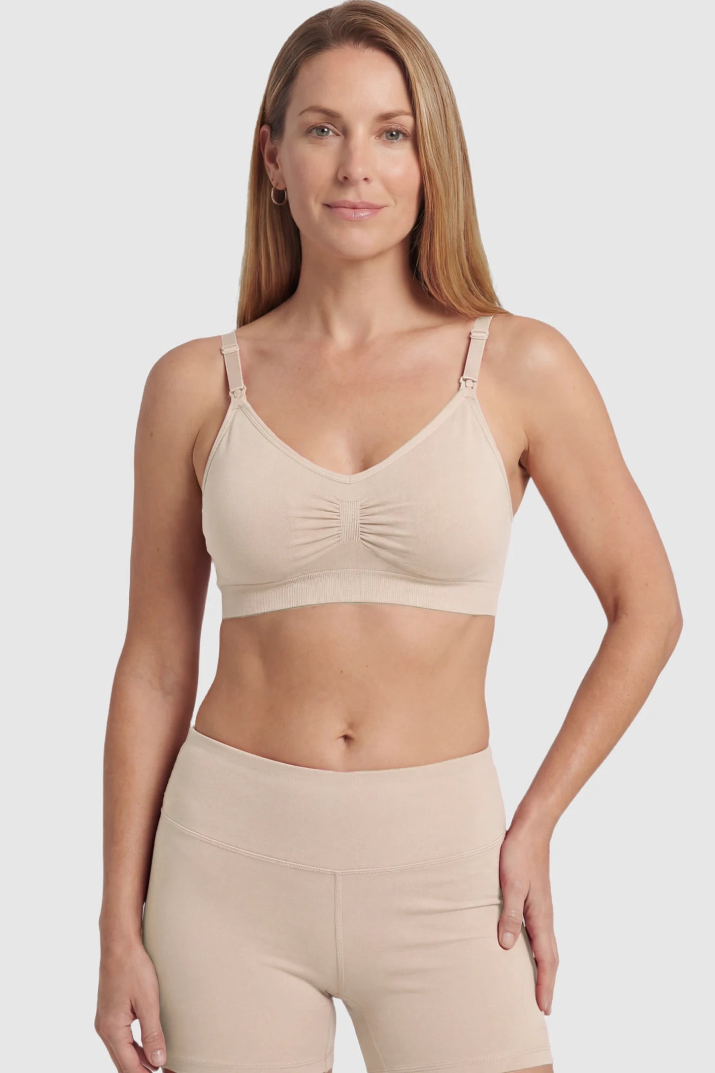 Seamless Ruched Front Maternity Nursing Bra Seamless Ruched Front Maternity Nursing Bra in skin featuring ribbed fabric and drop-down clips on a postpartum model showing front.