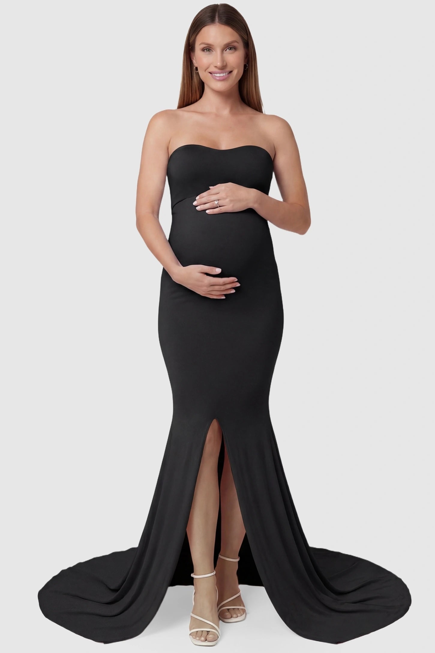 Strapless Sweetheart Neckline Trumpet Silhouette Maternity Gown Strapless Sweetheart Neckline Trumpet Silhouette Maternity Gown in Black featuring a front slit on a pregnant model, front view.