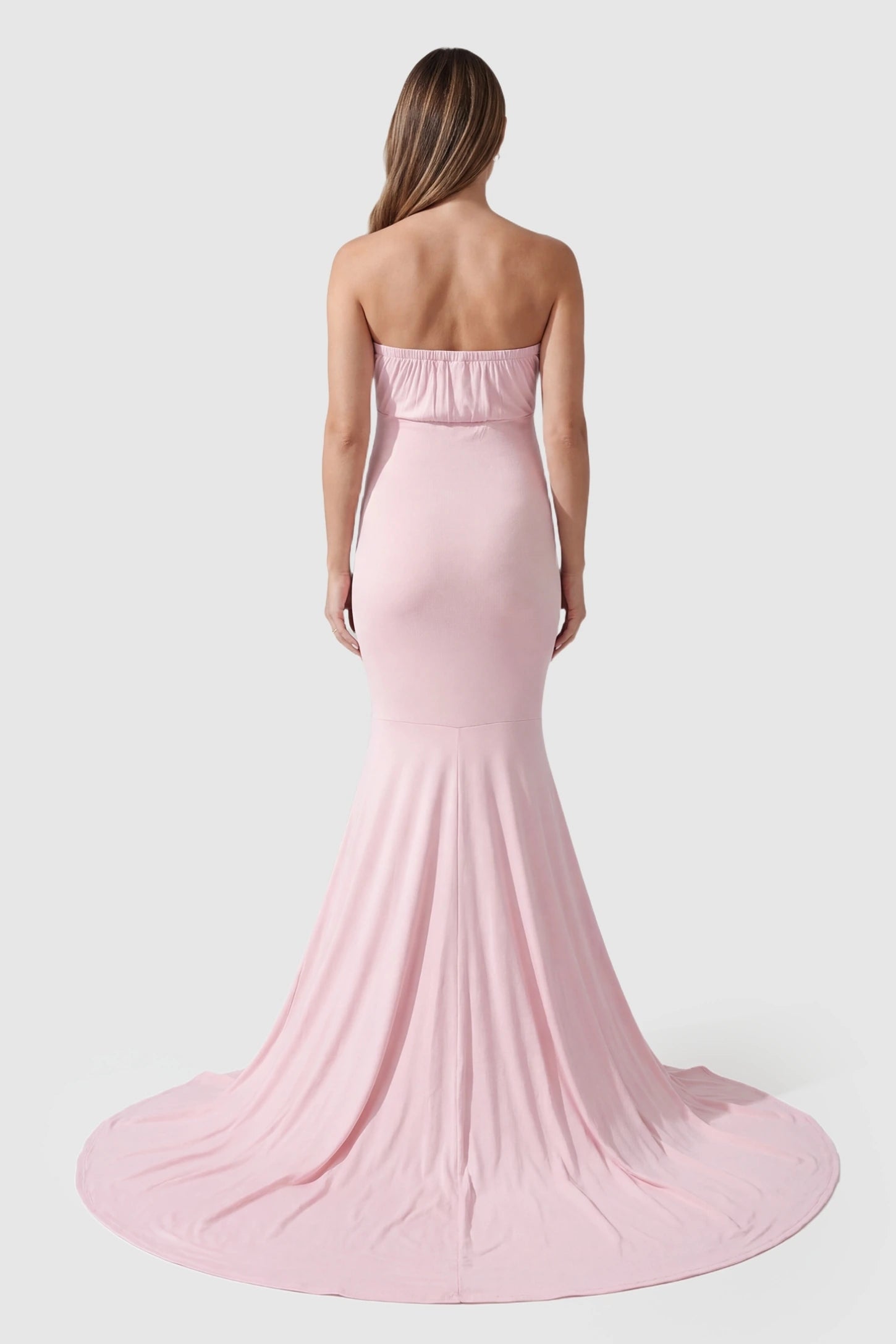 Strapless Sweetheart Neckline Trumpet Silhouette Maternity Gown Strapless Sweetheart Neckline Trumpet Silhouette Maternity Gown in Pink featuring a cinched back on a pregnant model, back view.