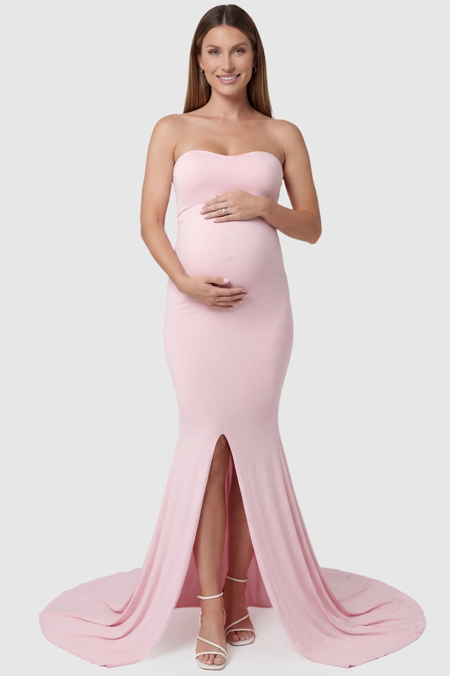 Strapless Sweetheart Neckline Trumpet Silhouette Maternity Gown Strapless Sweetheart Neckline Trumpet Silhouette Maternity Gown in Pink featuring a front slit on a pregnant model, front view.