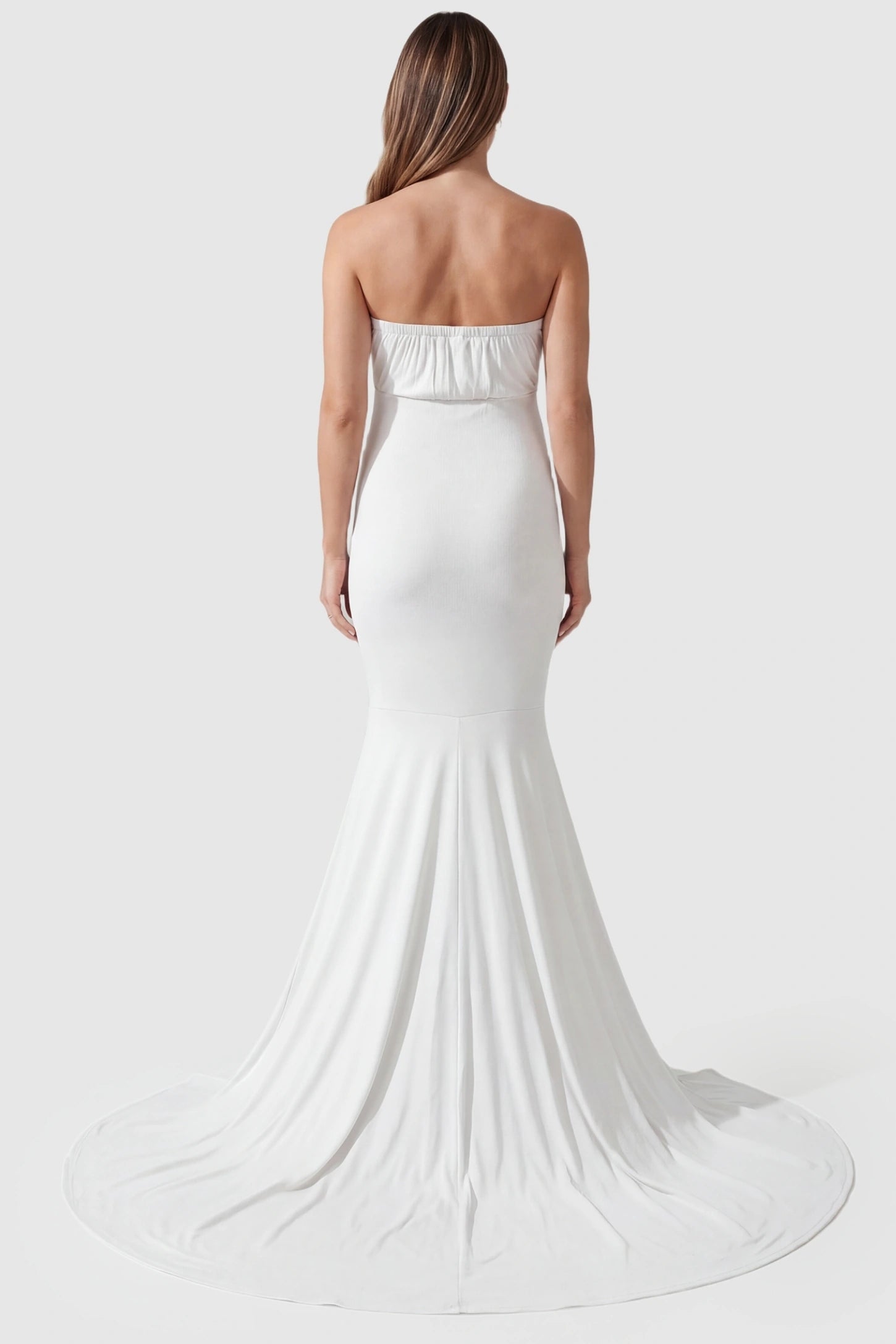Strapless Sweetheart Neckline Trumpet Silhouette Maternity Gown Strapless Sweetheart Neckline Trumpet Silhouette Maternity Gown in White featuring a cinched back on a pregnant model, back view.