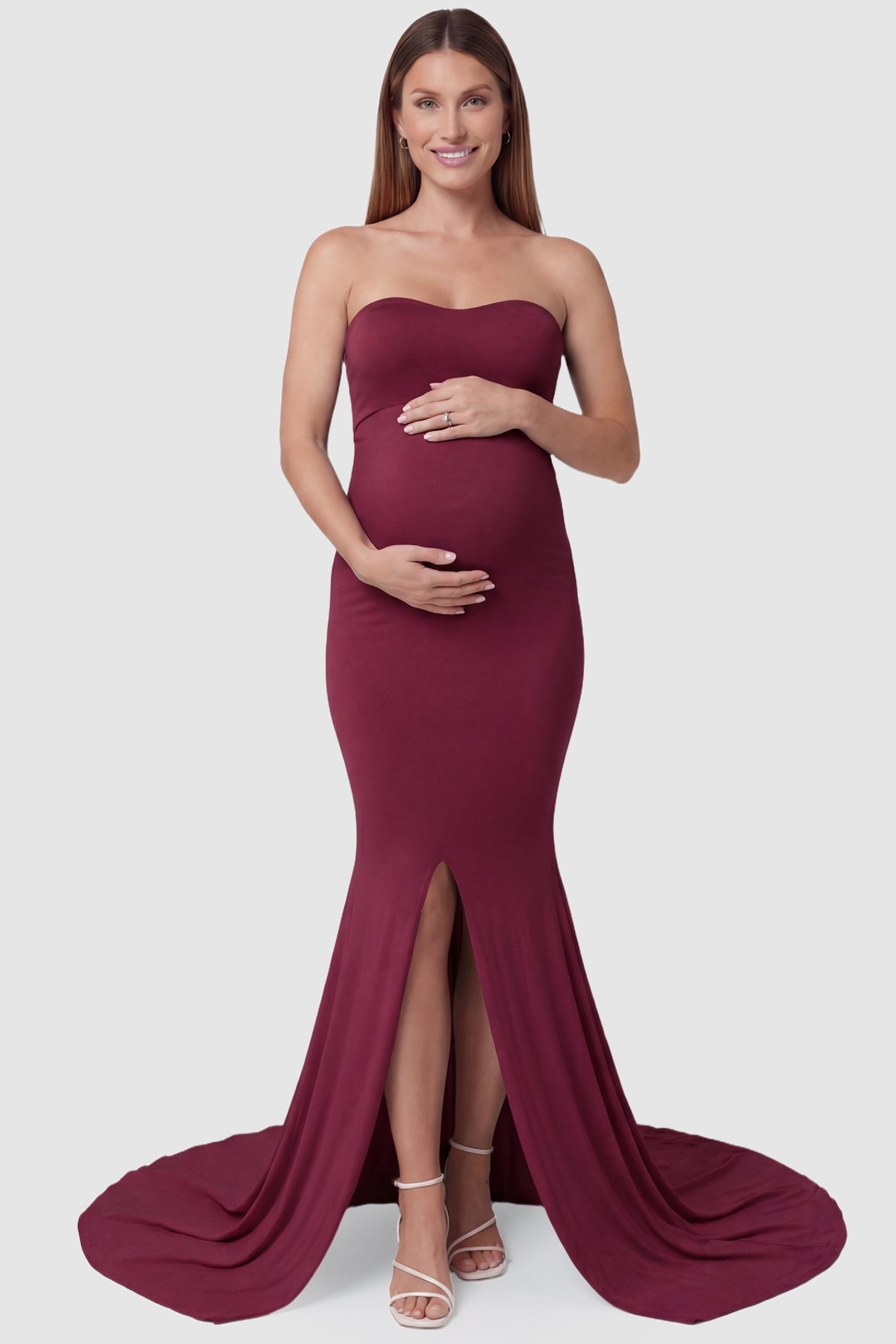 Strapless Sweetheart Neckline Trumpet Silhouette Maternity Gown Strapless Sweetheart Neckline Trumpet Silhouette Maternity Gown in Wine Red featuring a front slit on a pregnant model, front view.