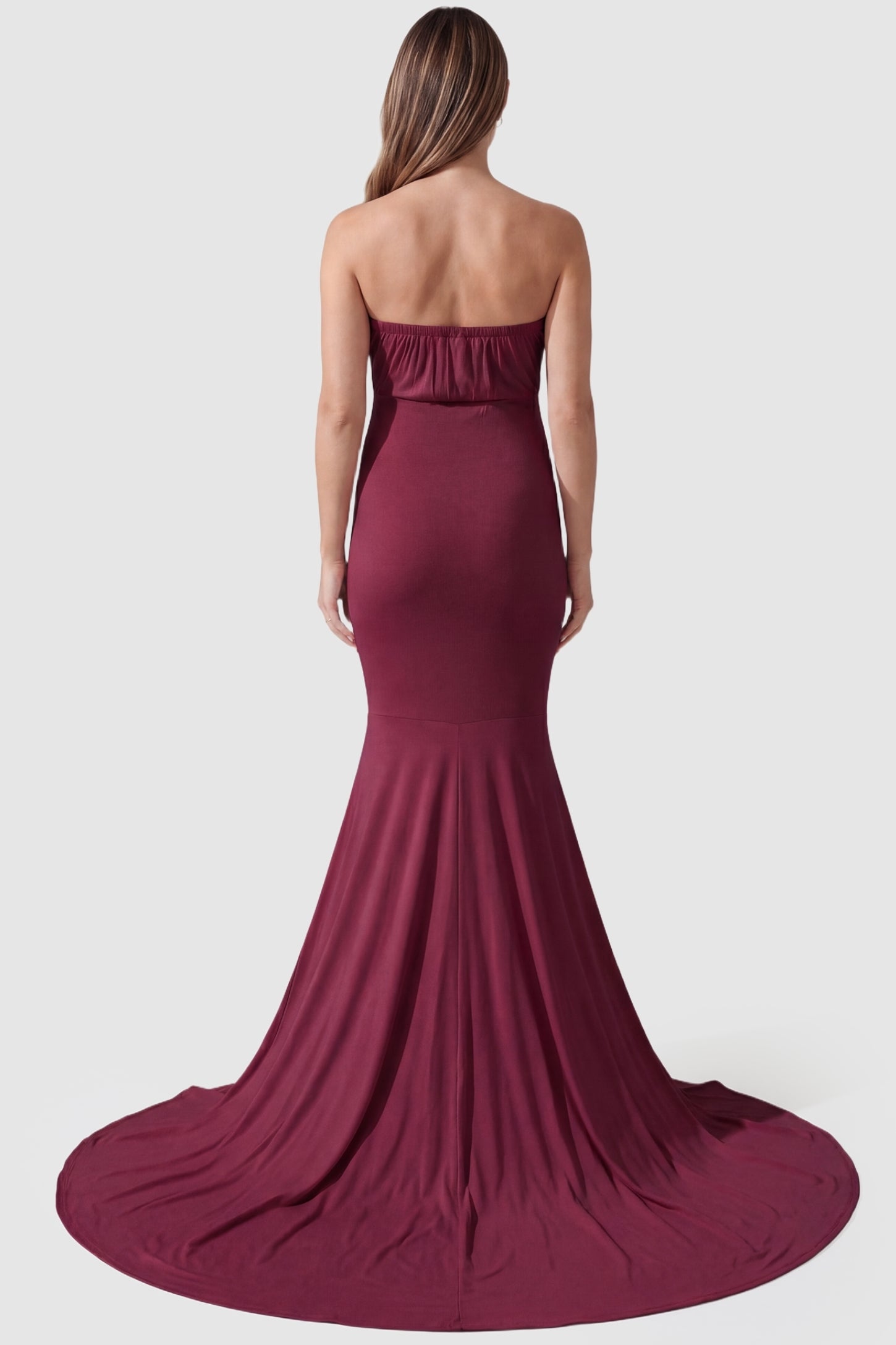 Strapless Sweetheart Neckline Trumpet Silhouette Maternity Gown Strapless Sweetheart Neckline Trumpet Silhouette Maternity Gown in Wine Red featuring a cinched back on a pregnant model, back view.