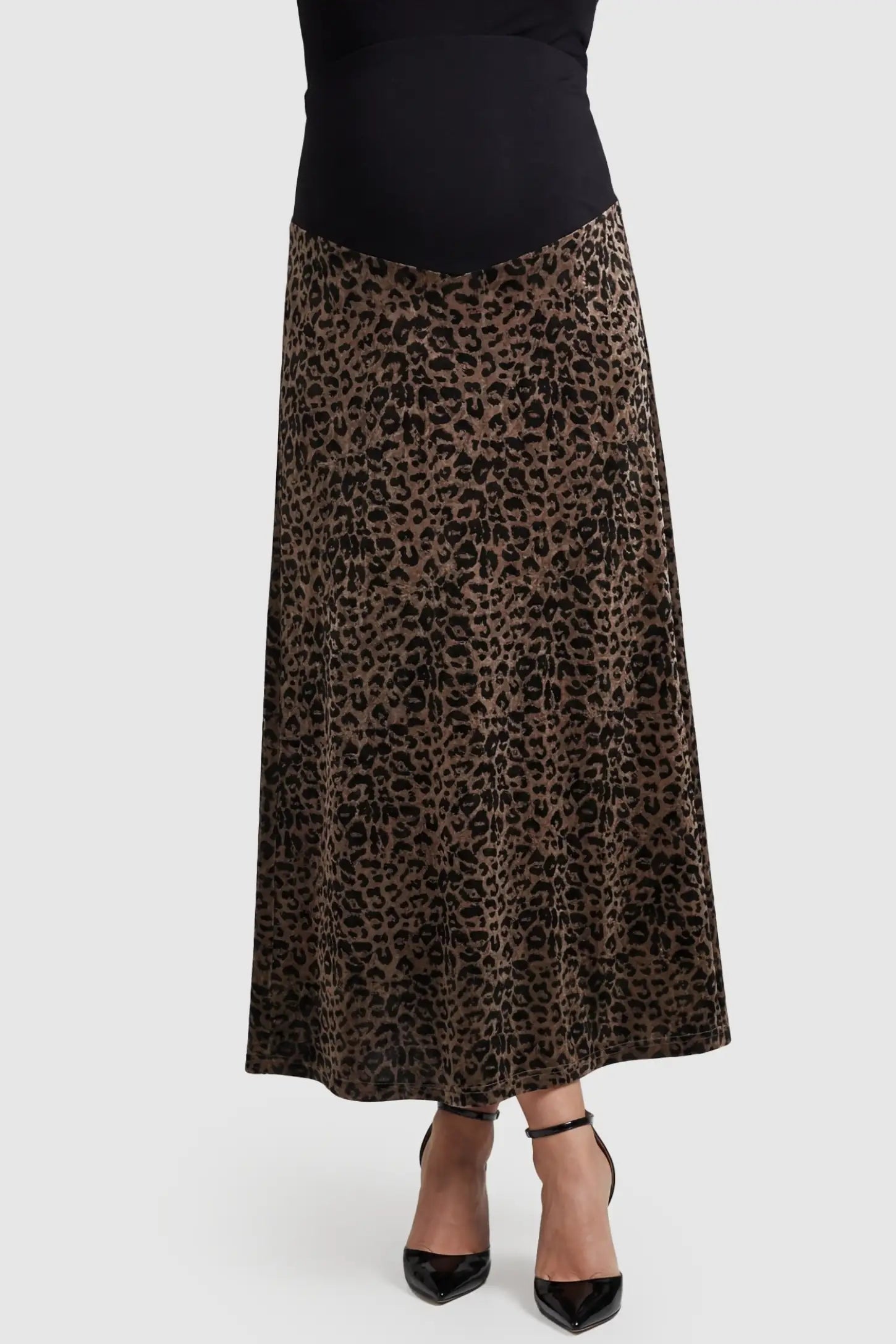Leopard Print Velvet High-Waisted Maternity Maxi Skirt in Coffee front view featuring a supportive belly band on a pregnant model.