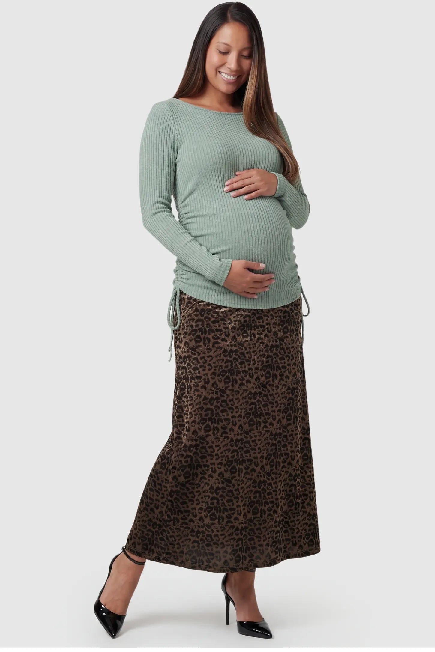 Leopard Print Velvet High-Waisted Maternity Maxi Skirt in Coffee front view featuring a supportive belly band on a pregnant model.