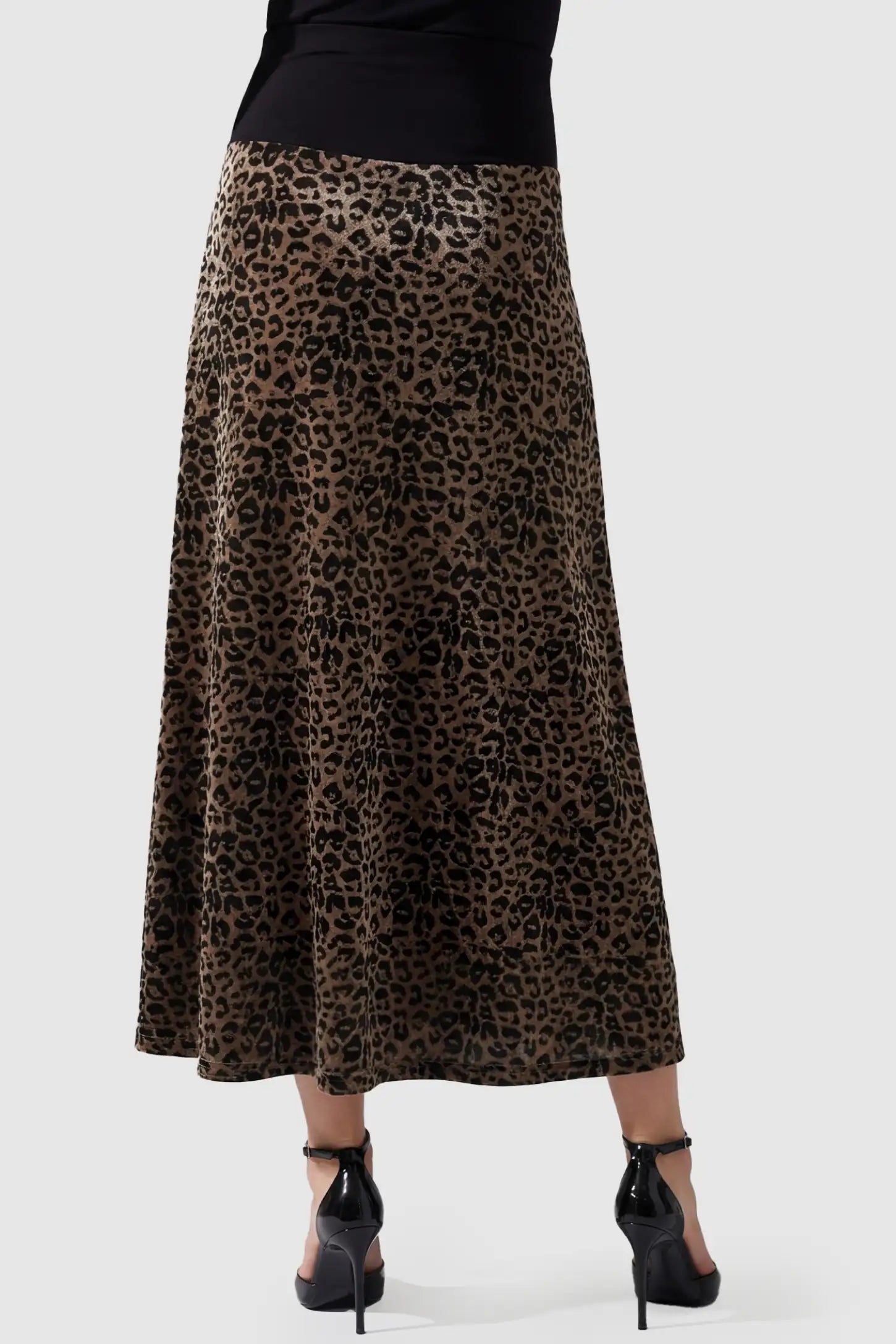 Leopard Print Velvet High-Waisted Maternity Maxi Skirt Leopard Print Velvet High-Waisted Maternity Maxi Skirt in Coffee back view featuring a flowy A-line silhouette on a pregnant model.