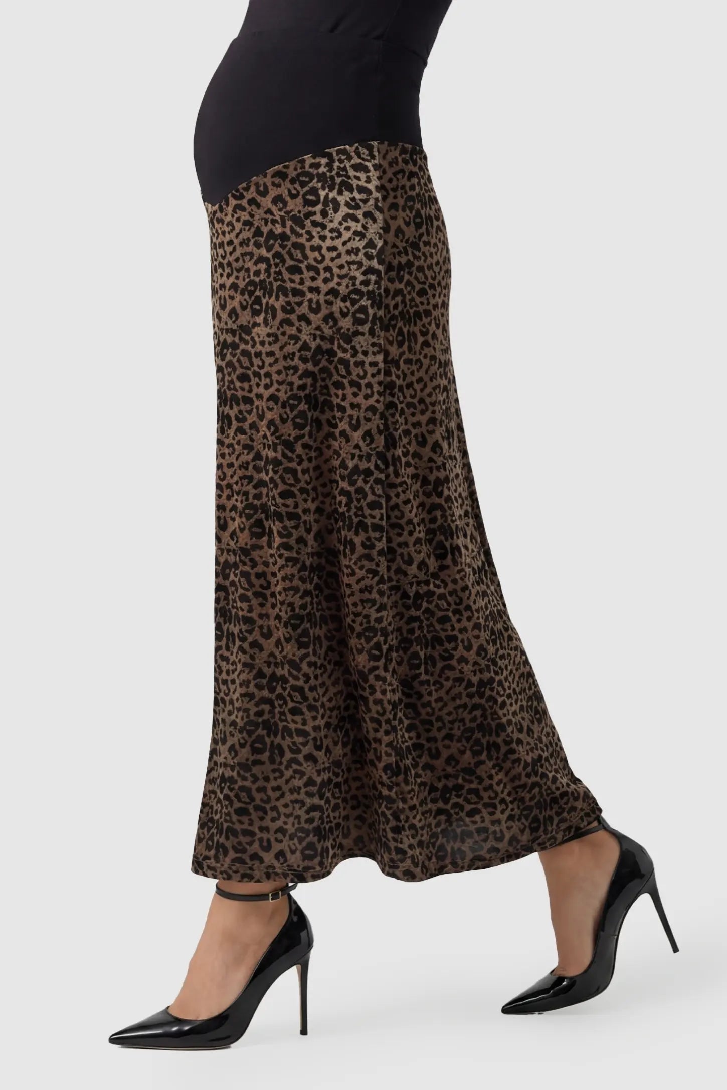 Leopard Print Velvet High-Waisted Maternity Maxi Skirt Leopard Print Velvet High-Waisted Maternity Maxi Skirt in Coffee side view featuring a smooth, high-waisted fit on a pregnant model.