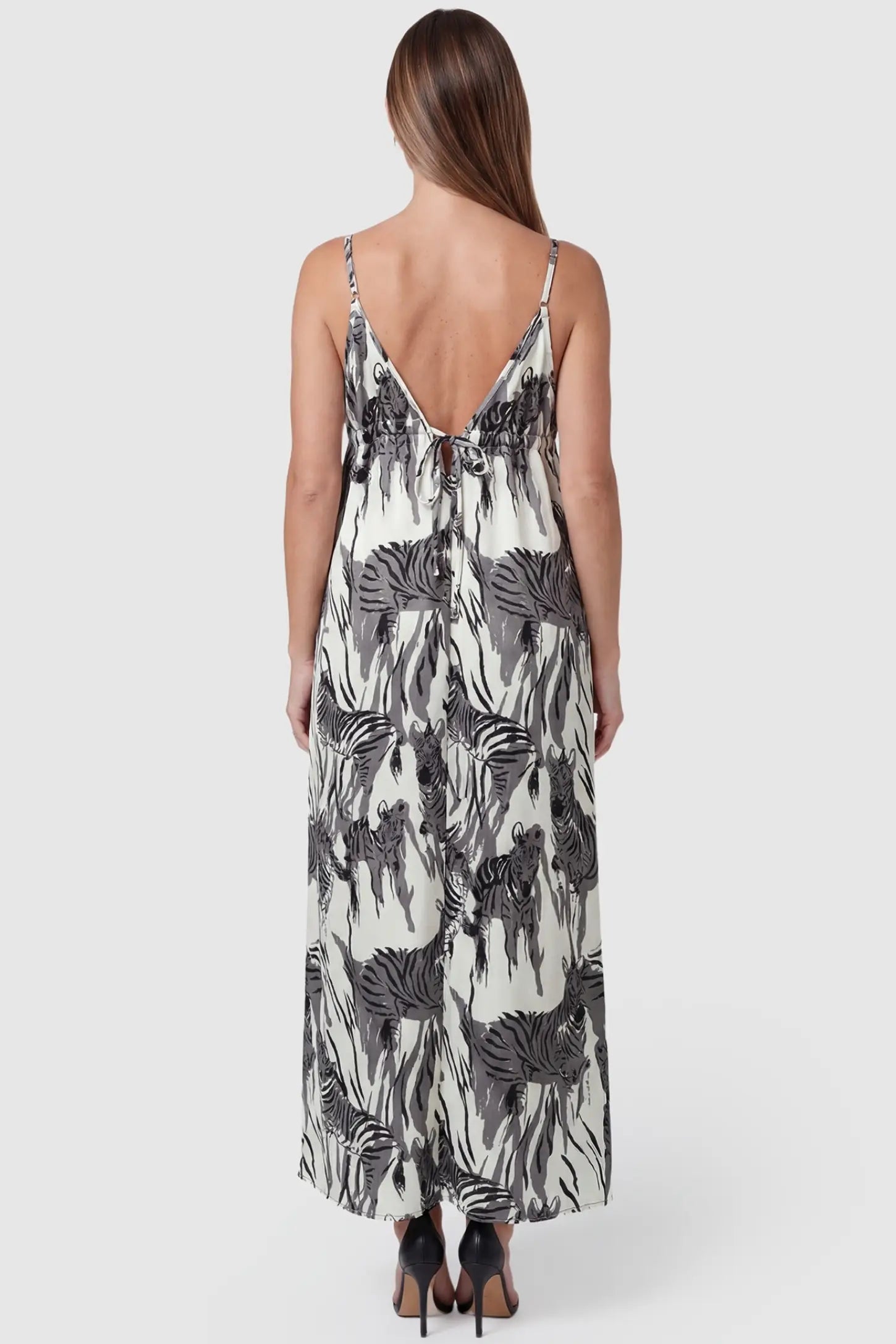 Zebra Print V-Neck Sleeveless Maxi Maternity Dress Zebra Print V-Neck Sleeveless Maxi Maternity Dress in Gray featuring an adjustable back tie detail on a back view pregnant model.