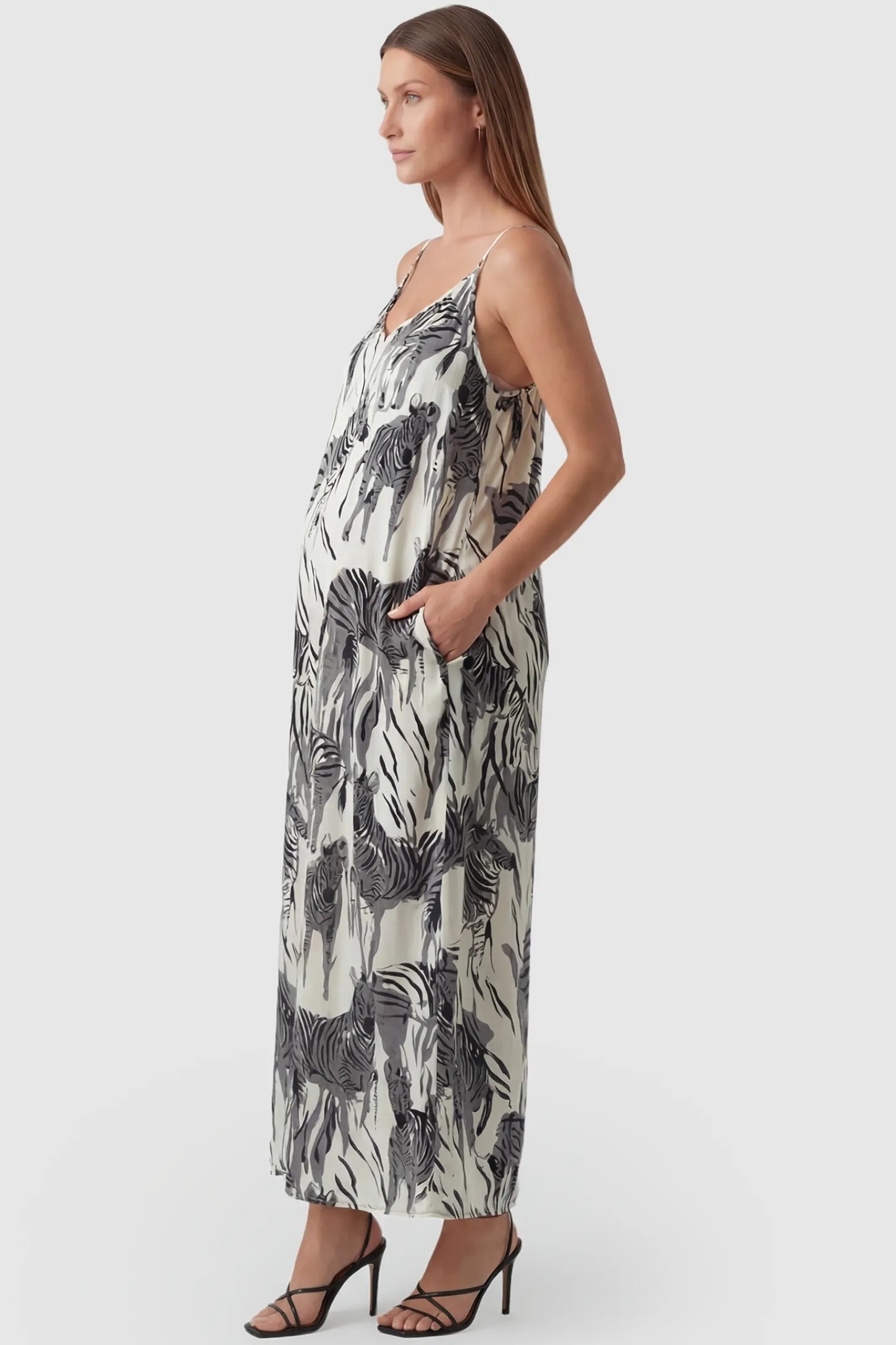 Zebra Print V-Neck Sleeveless Maxi Maternity Dress Zebra Print V-Neck Sleeveless Maxi Maternity Dress in Gray featuring functional side pockets on a side view pregnant model.