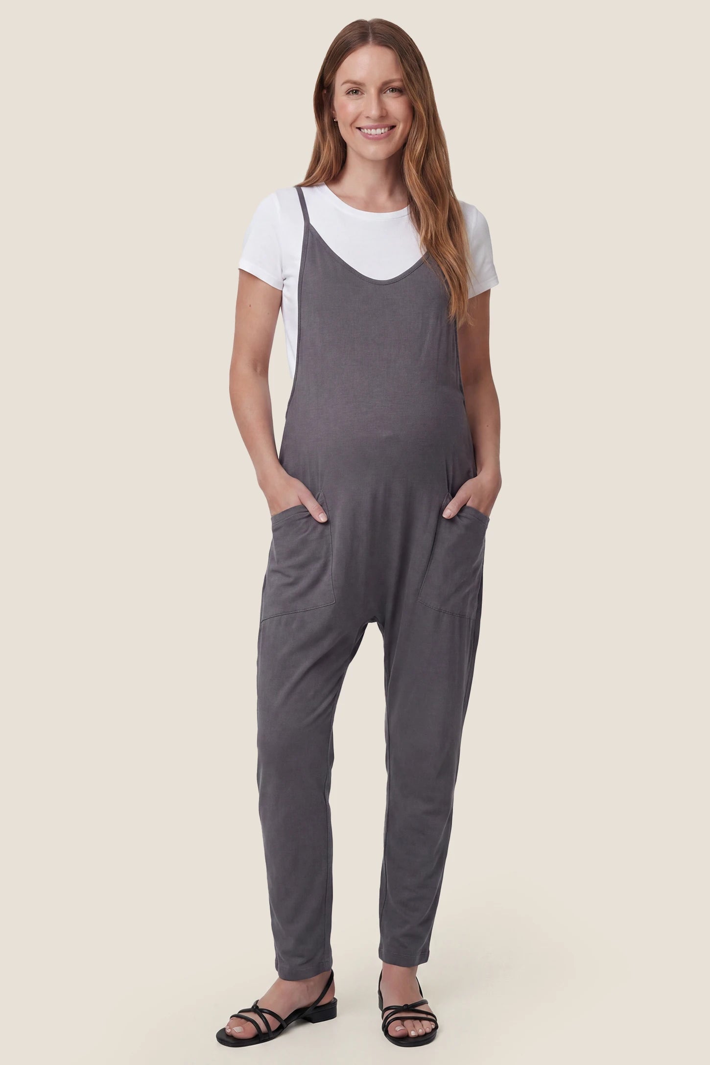 Adjustable Strap Pocketed Relaxed Maternity Jumpsuit Front view of dark gray adjustable strap pocketed relaxed maternity jumpsuit
