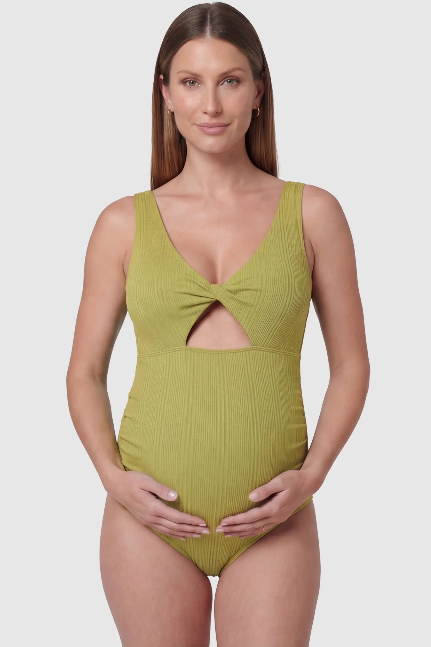 Cutout V-Neck Maternity Swimsuit Cutout V-Neck Maternity Swimsuit in Matcha featuring a front view of the supportive v-neckline on a pregnant model.