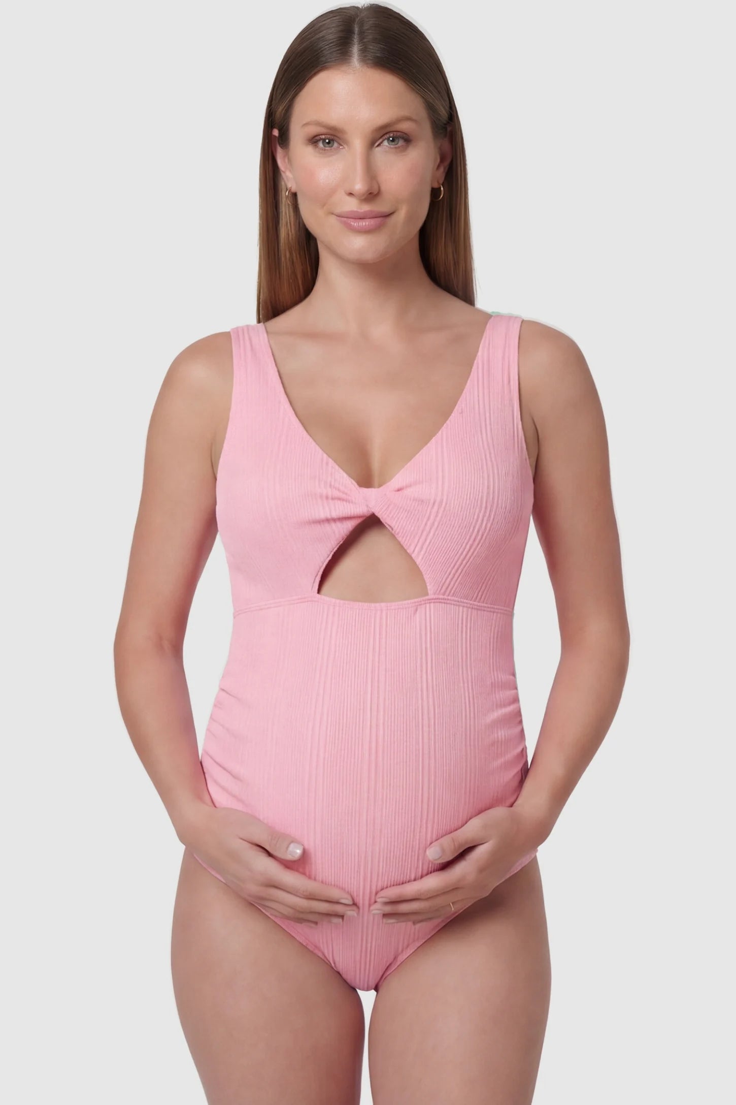 Cutout V-Neck Maternity Swimsuit Cutout V-Neck Maternity Swimsuit in Pink featuring a front view of the stylish center cutout on a pregnant model.