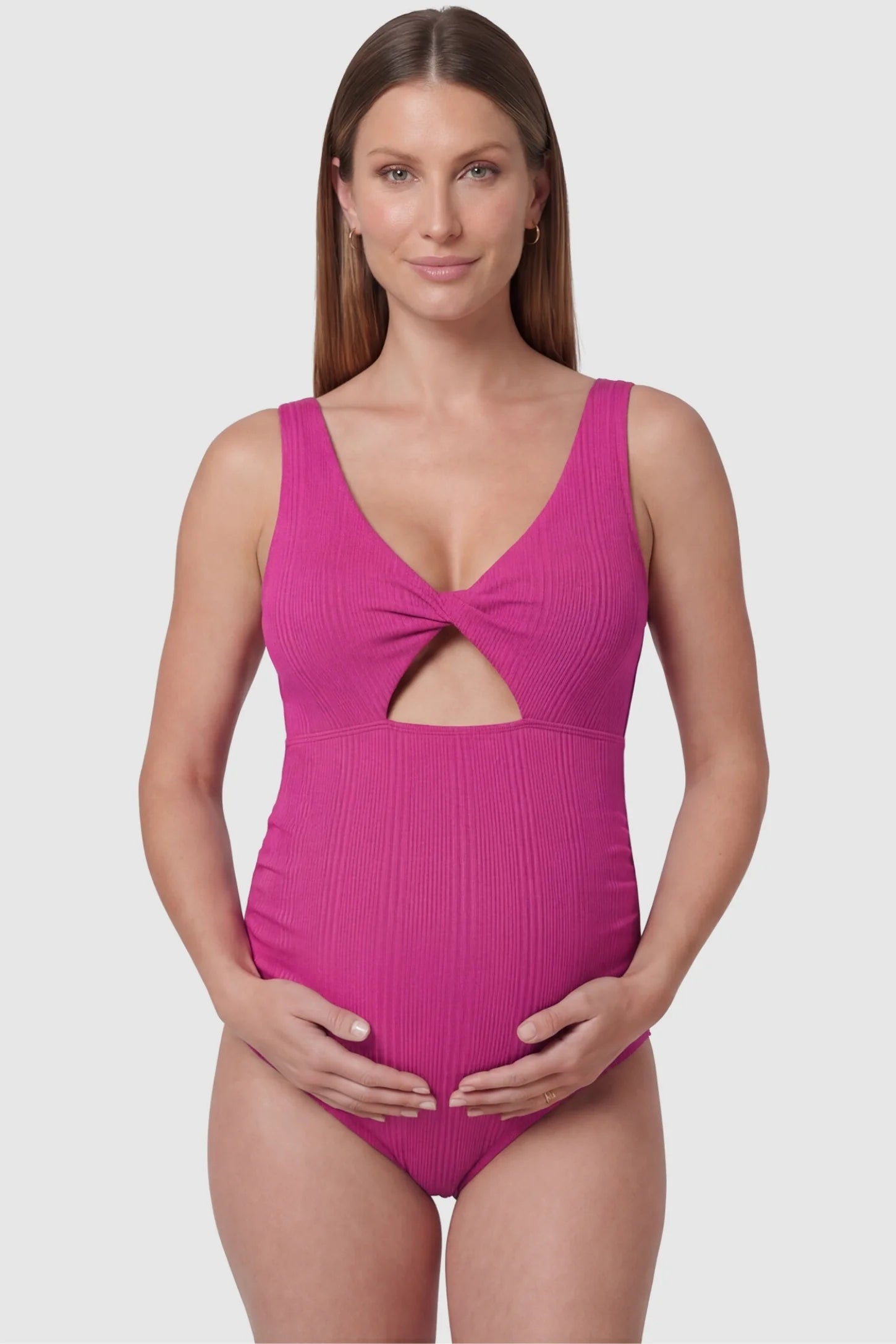 Cutout V-Neck Maternity Swimsuit Cutout V-Neck Maternity Swimsuit in Rose Red featuring a front view of the abdomen cutout on a pregnant model.
