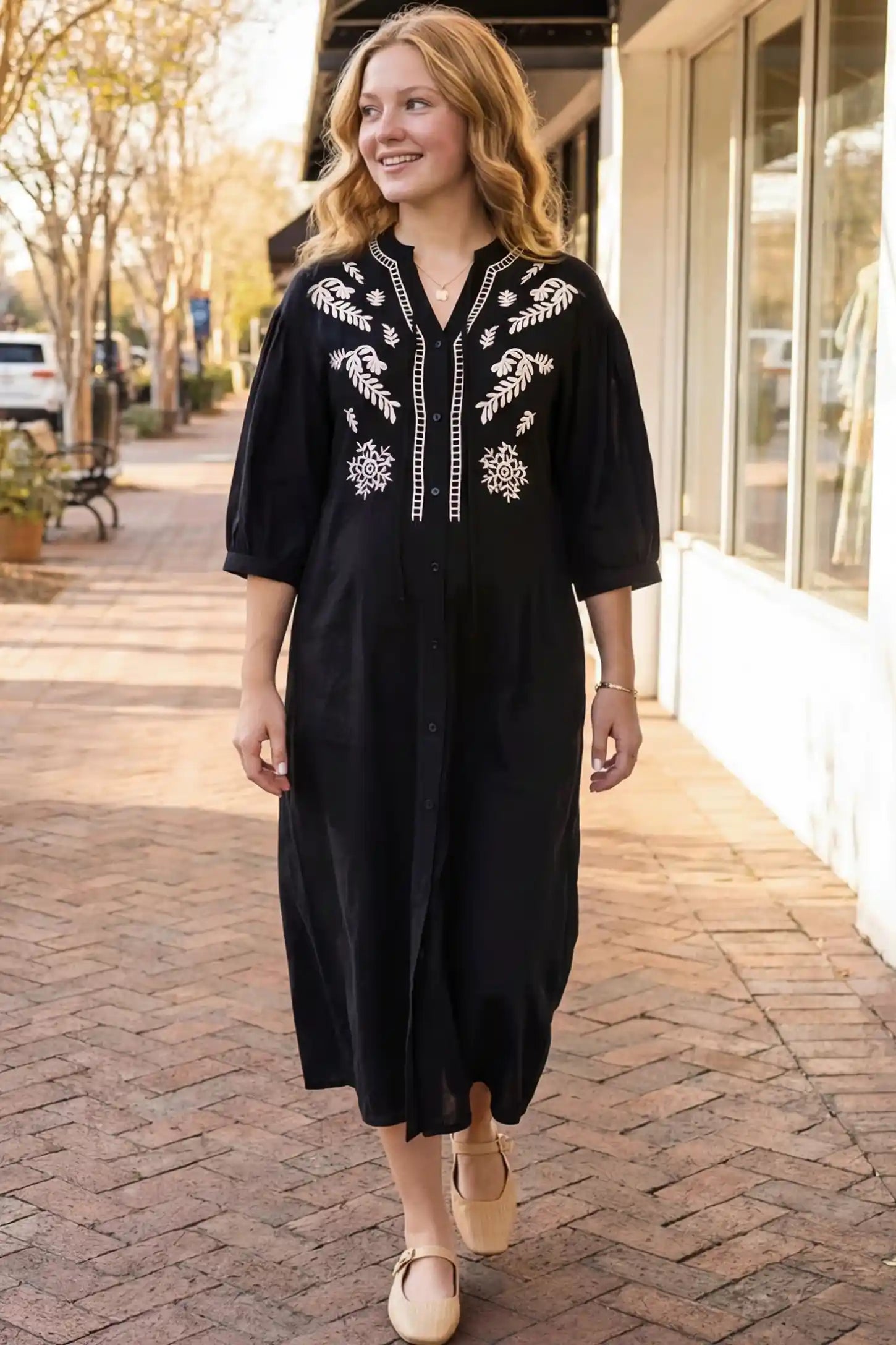 Front view of Black Embroidered Notched Half Sleeve Maternity Midi Dress featuring a button-down front on a non-pregnant model.