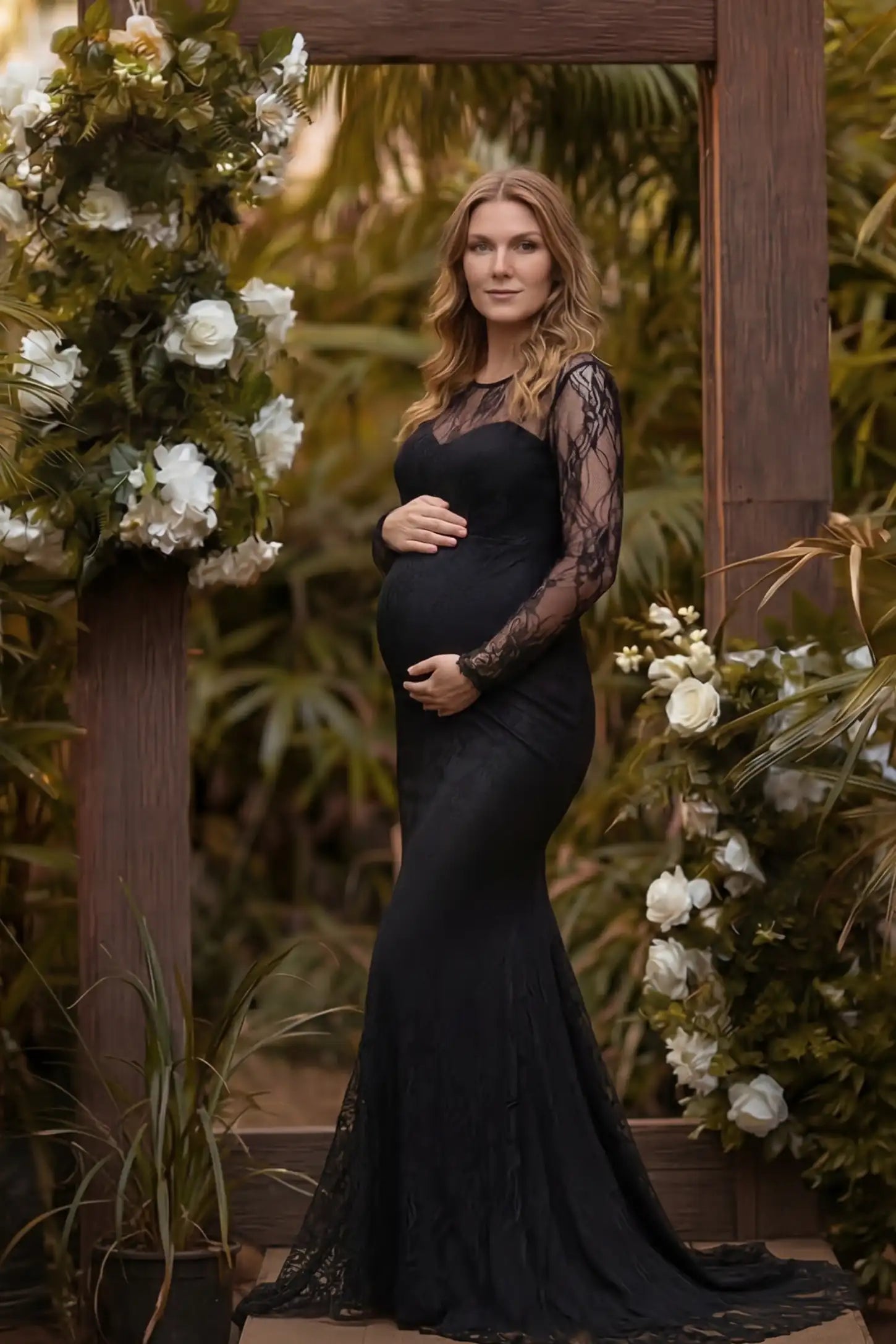 Floral Lace Long Sleeve Trumpet Maternity Photoshoot Gown Floral Lace Long Sleeve Trumpet Maternity Photoshoot Gown in Black featuring a dramatic trumpet flare on a pregnant model.