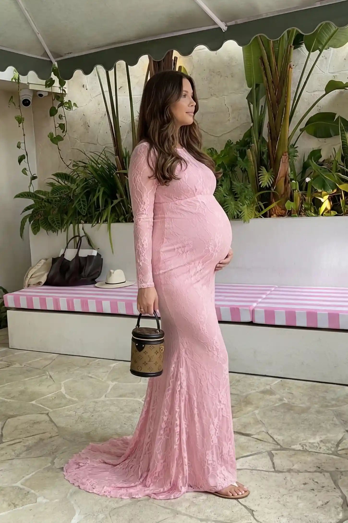 Floral Lace Long Sleeve Trumpet Maternity Photoshoot Gown Floral Lace Long Sleeve Trumpet Maternity Photoshoot Gown in Pink featuring a form-fitting lace bodice on a pregnant model.