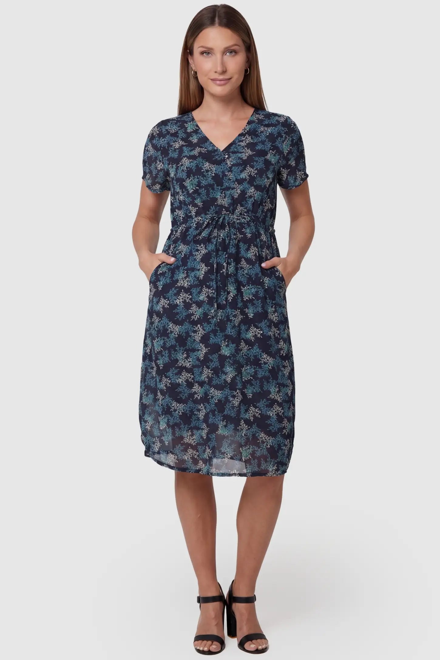 Floral V-Neck Knee-Length Maternity & Nursing Dress in Blue featuring a crossover neckline on a pregnant model, front view.