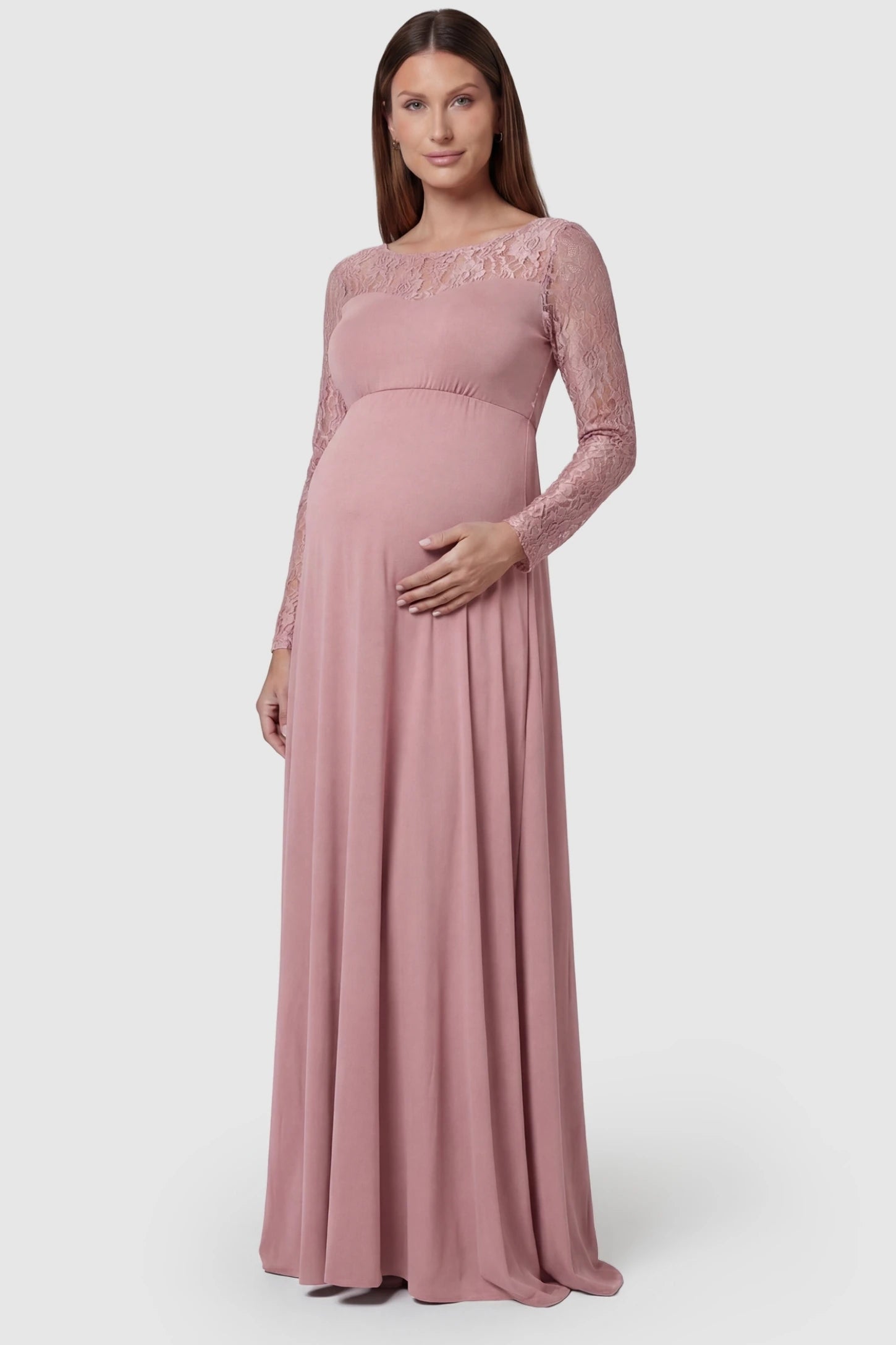 Acrylic Lace Long Sleeve Floor-Length Maternity Dress Acrylic Lace Long Sleeve Floor-Length Maternity Dress in Pink featuring a round neck on a front-facing pregnant model.