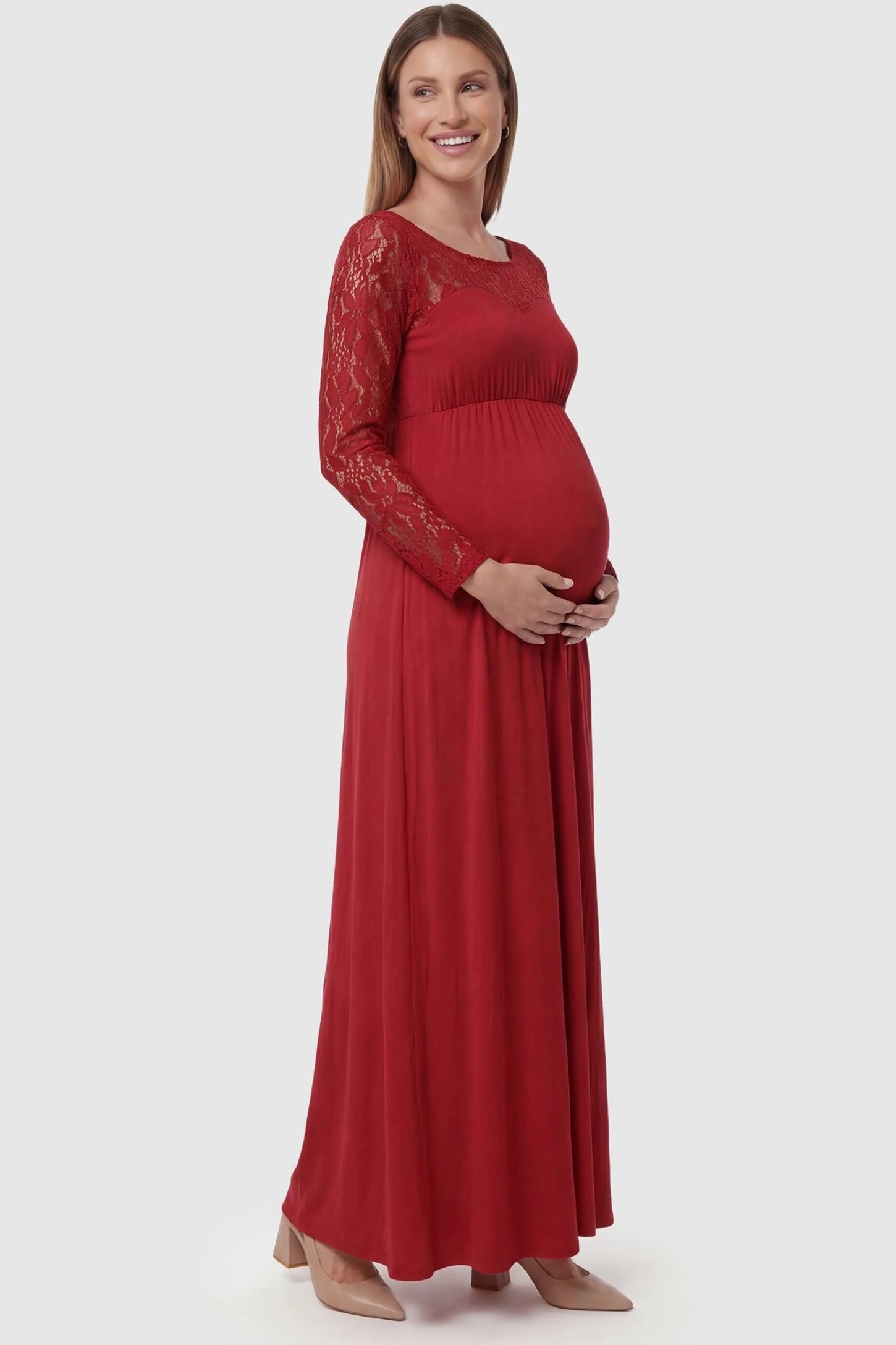 Acrylic Lace Long Sleeve Floor-Length Maternity Dress Acrylic Lace Long Sleeve Floor-Length Maternity Dress in Red featuring lace-spliced sleeves on a side-profile pregnant model.