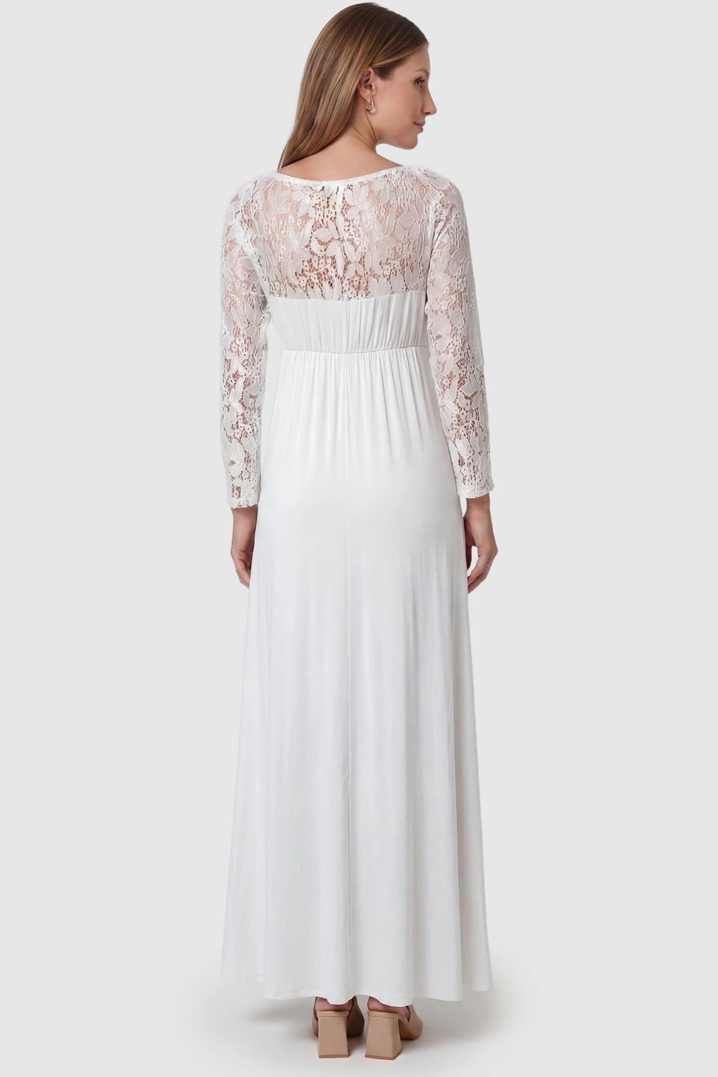 Acrylic Lace Long Sleeve Floor-Length Maternity Dress Acrylic Lace Long Sleeve Floor-Length Maternity Dress in White featuring a sheer lace back on a pregnant model.