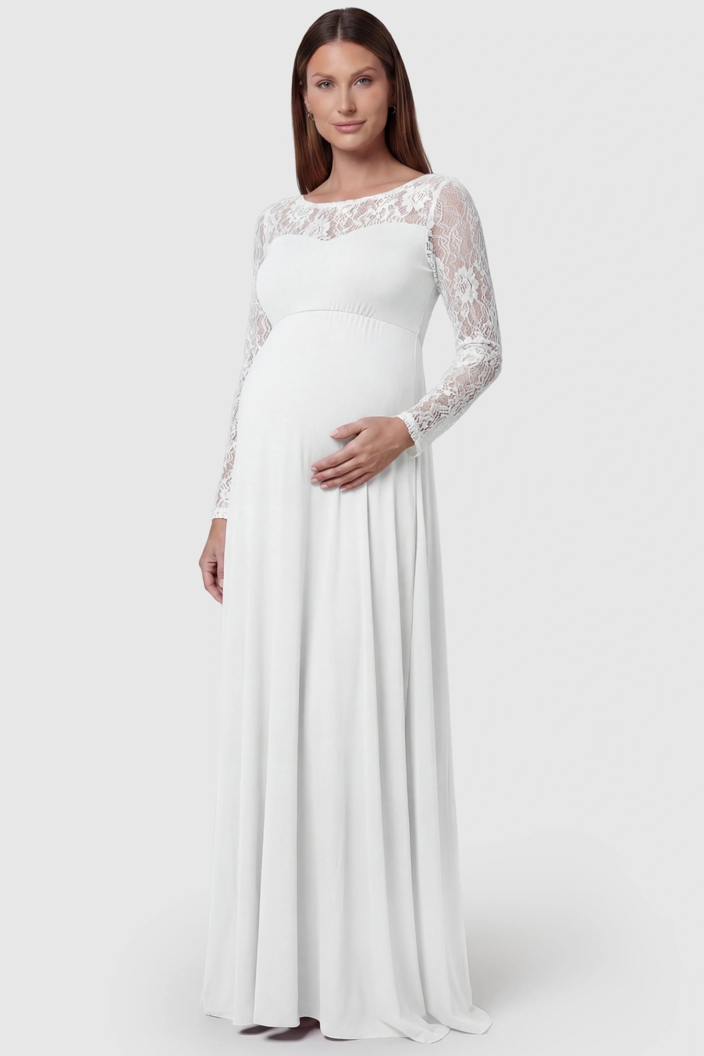 Acrylic Lace Long Sleeve Floor-Length Maternity Dress Acrylic Lace Long Sleeve Floor-Length Maternity Dress in White featuring a round neck on a front-facing pregnant model.
