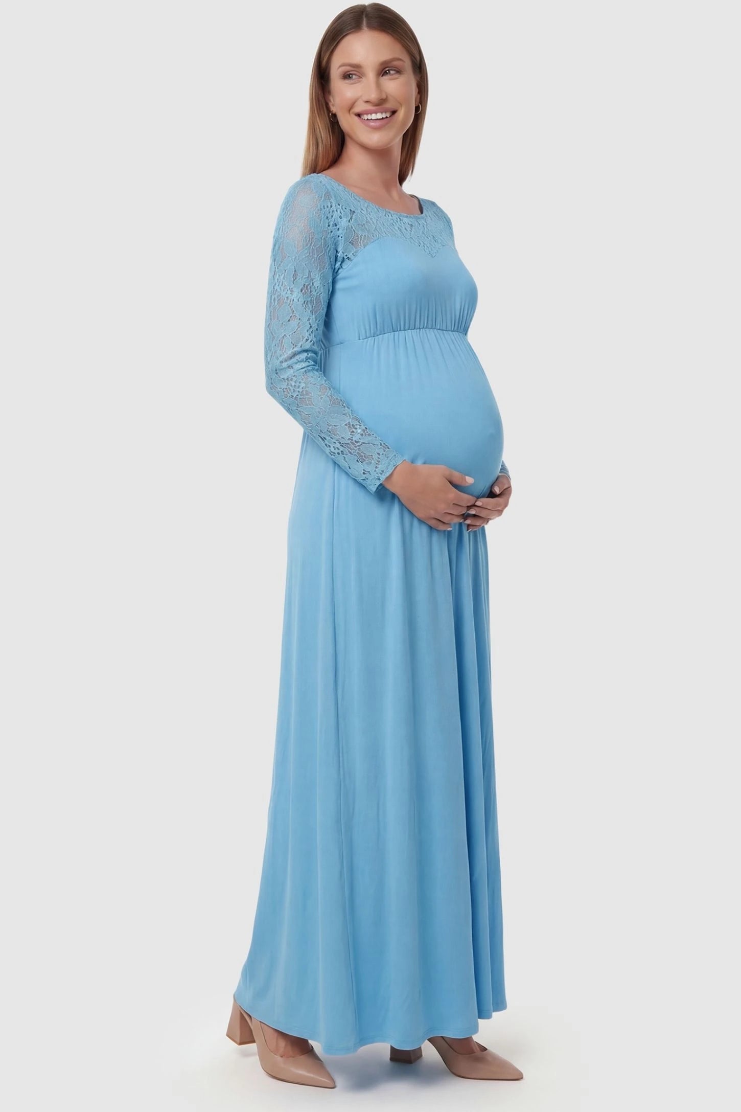 Acrylic Lace Long Sleeve Floor-Length Maternity Dress Acrylic Lace Long Sleeve Floor-Length Maternity Dress in Light Blue featuring lace-spliced sleeves on a side-profile pregnant model.