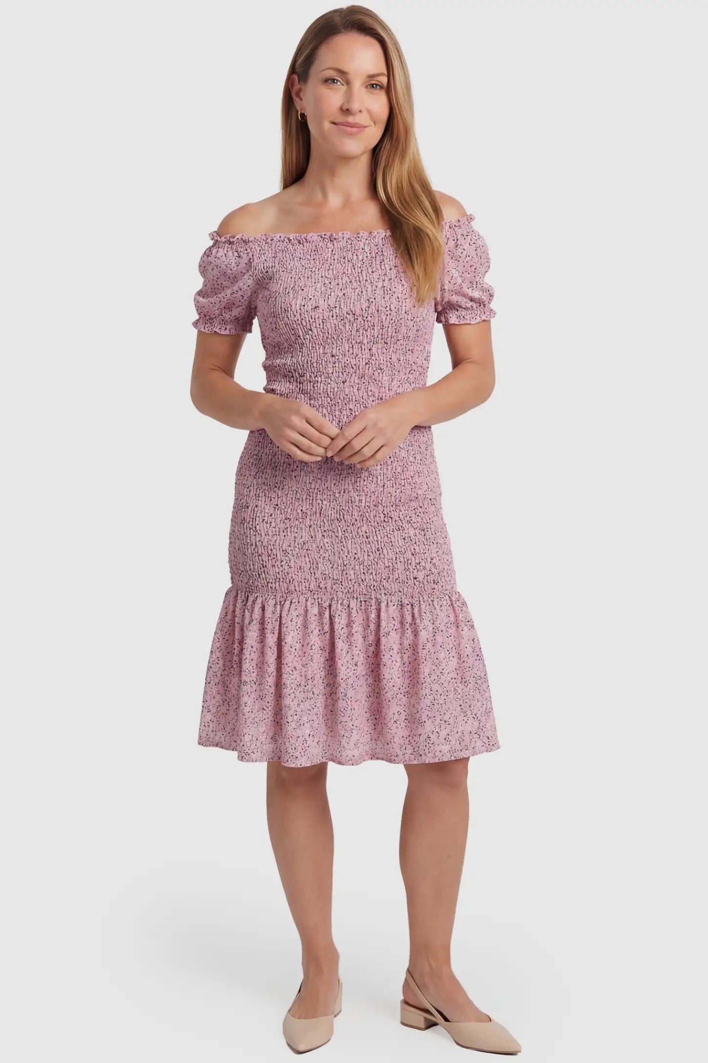 Floral Off Shoulder Smocked Maternity Fishtail Dress Floral Off Shoulder Smocked Maternity Fishtail Dress in Pink Floral featuring a feminine fishtail hem on a non-pregnant model.