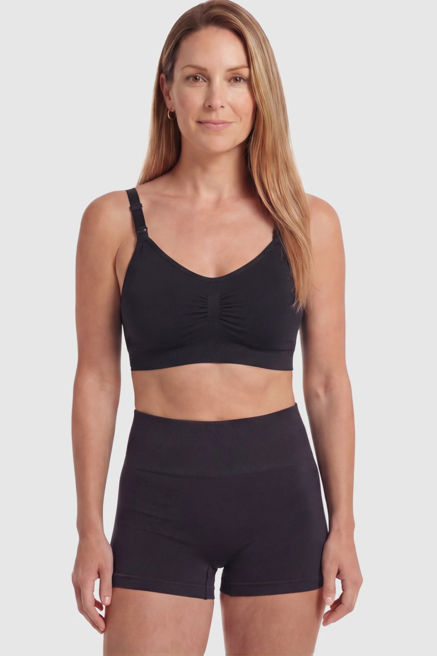 Seamless Ruched Front Wireless Maternity Nursing Bra Seamless Ruched Wireless Nursing Bra in Black with one-handed clips and adaptive stretch on a postpartum model.