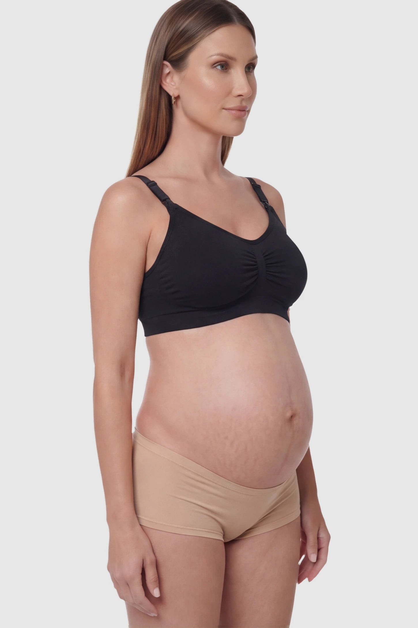 Seamless Ruched Front Wireless Maternity Nursing Bra Seamless Ruched Wireless Nursing Bra in Black with one-handed clips and adaptive stretch on a pregnant model.