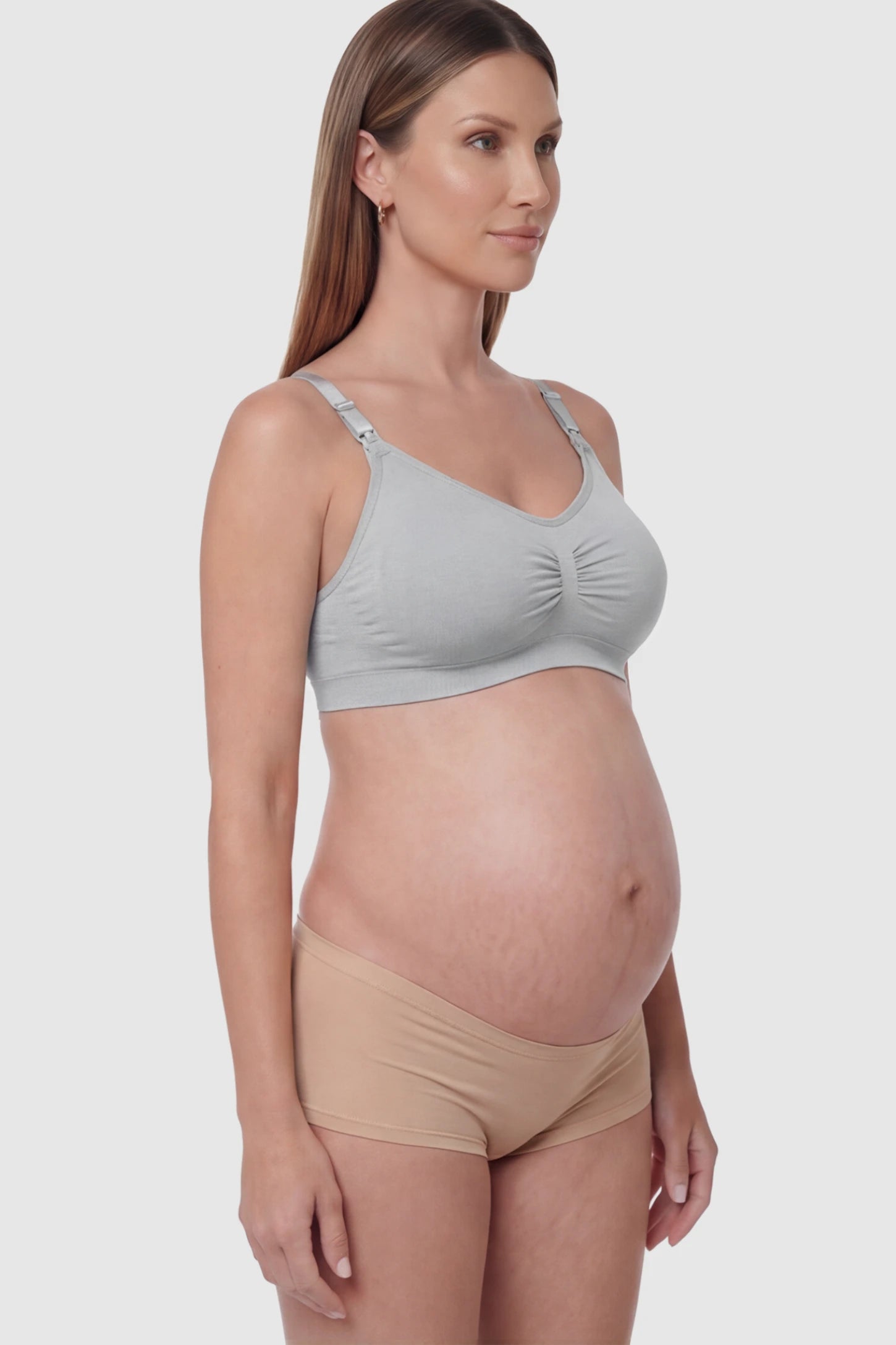 Seamless Ruched Front Wireless Maternity Nursing Bra Seamless Ruched Wireless Nursing Bra in Gray with one-handed clips and adaptive stretch on a pregnant model.