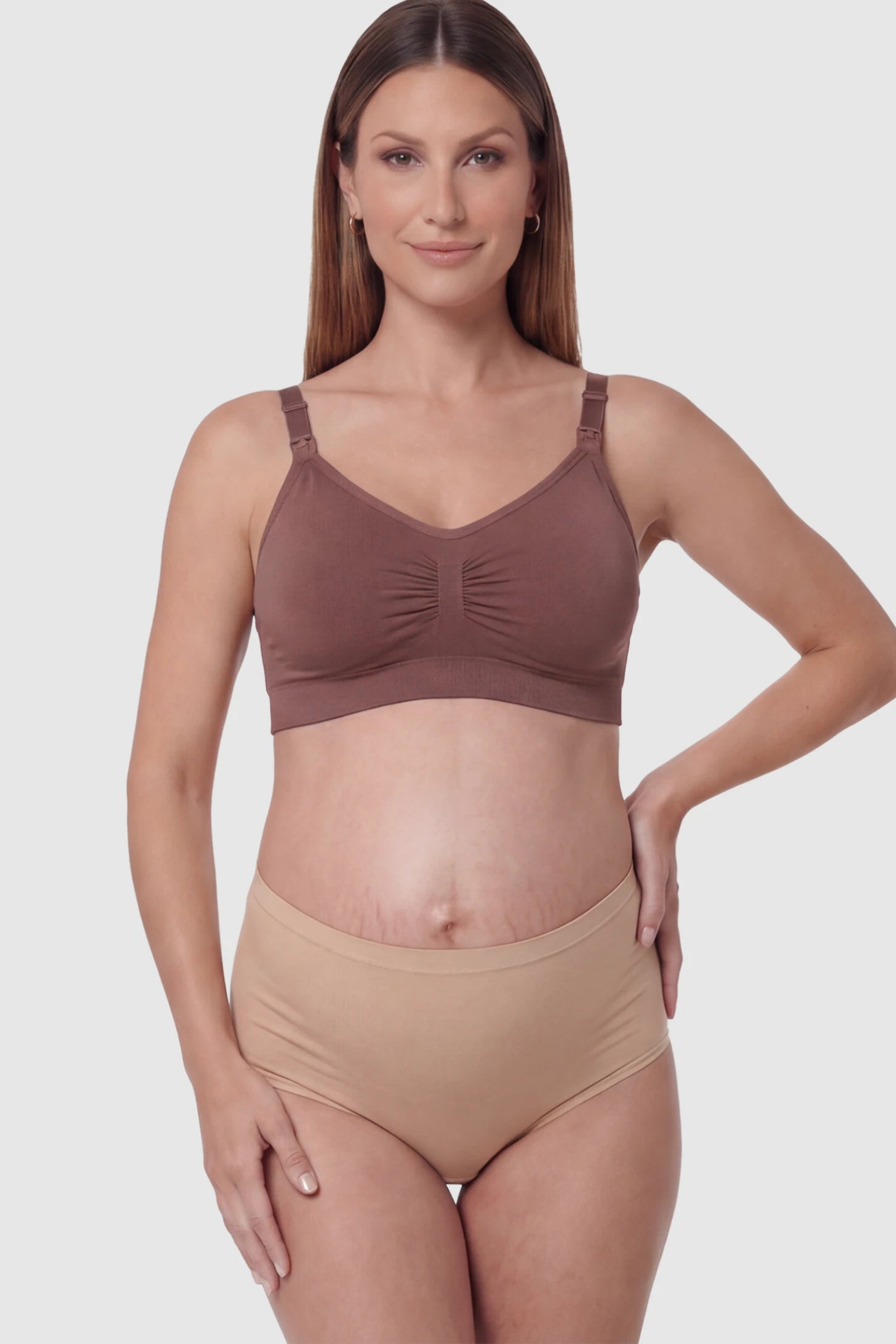 Seamless Ruched Front Wireless Maternity Nursing Bra Seamless Ruched Wireless Nursing Bra in Light Brown Red with one-handed clips and adaptive stretch on a pregnant model.
