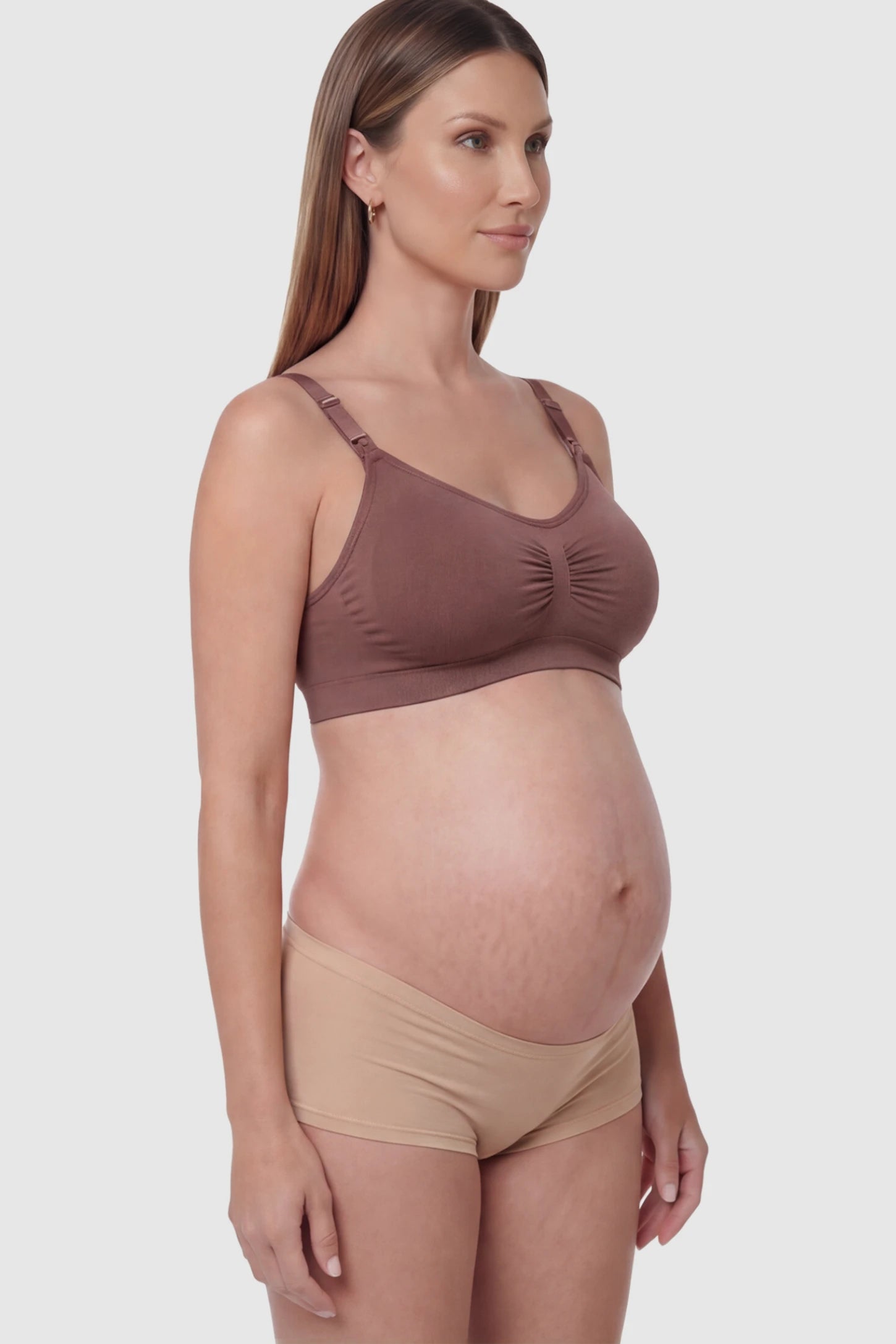 Seamless Ruched Front Wireless Maternity Nursing Bra Seamless Ruched Wireless Nursing Bra in Light Brown Red with one-handed clips and adaptive stretch on a pregnant model.
