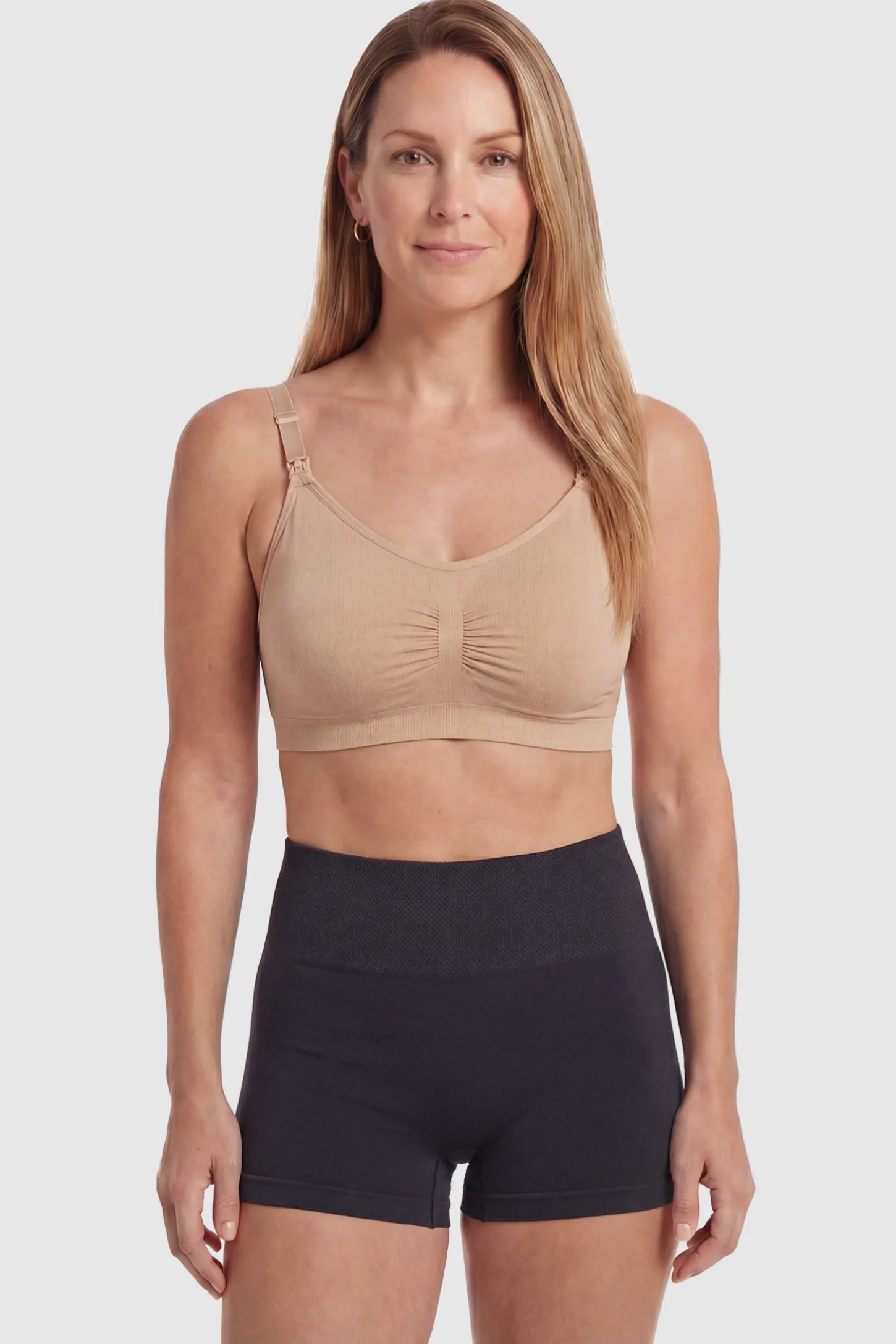 Seamless Ruched Front Wireless Maternity Nursing Bra Seamless Ruched Wireless Nursing Bra in Lotus Root Pink with one-handed clips and adaptive stretch on a postpartum model.