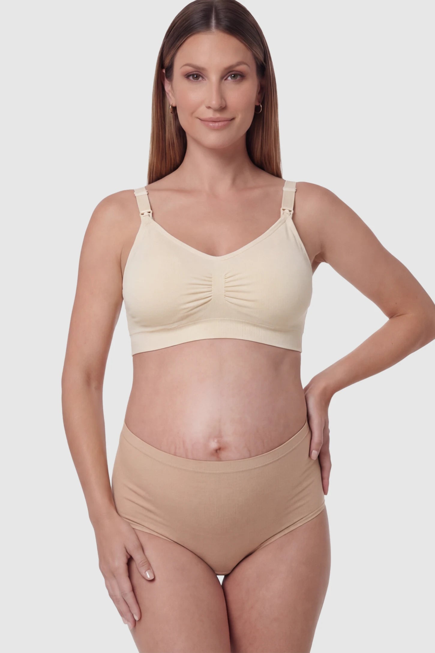 Seamless Ruched Front Wireless Maternity Nursing Bra Seamless Ruched Wireless Nursing Bra in Skin with one-handed clips and adaptive stretch on a pregnant model.