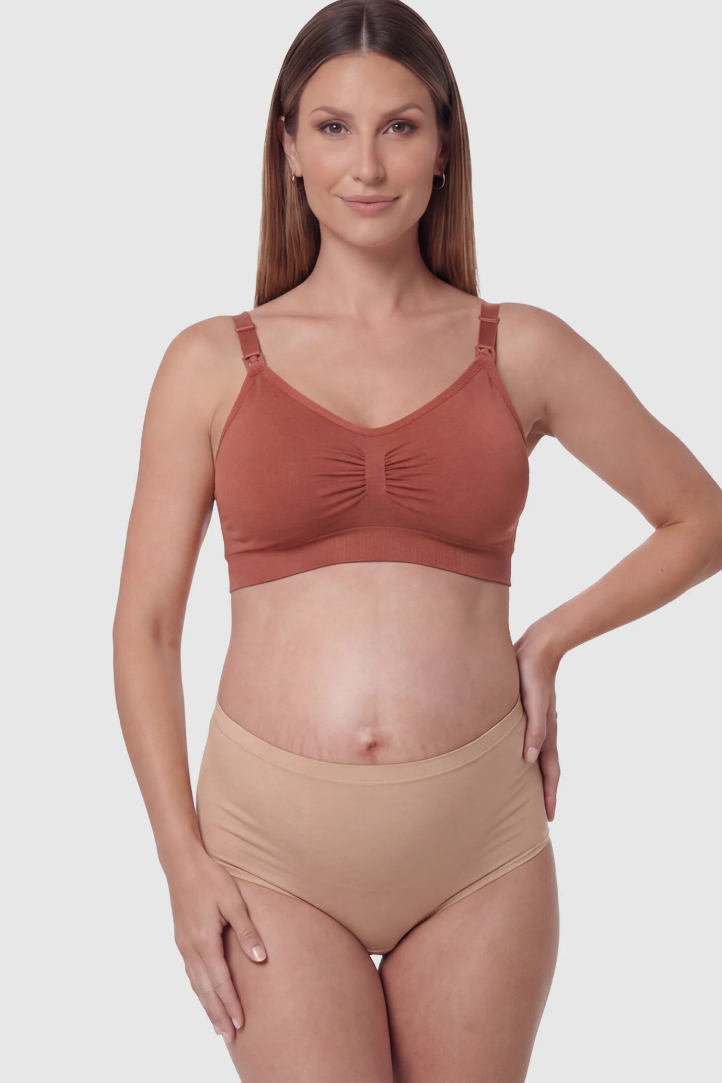 Seamless Ruched Front Wireless Maternity Nursing Bra Seamless Ruched Wireless Nursing Bra in Wine Red with one-handed clips and adaptive stretch on a pregnant model.